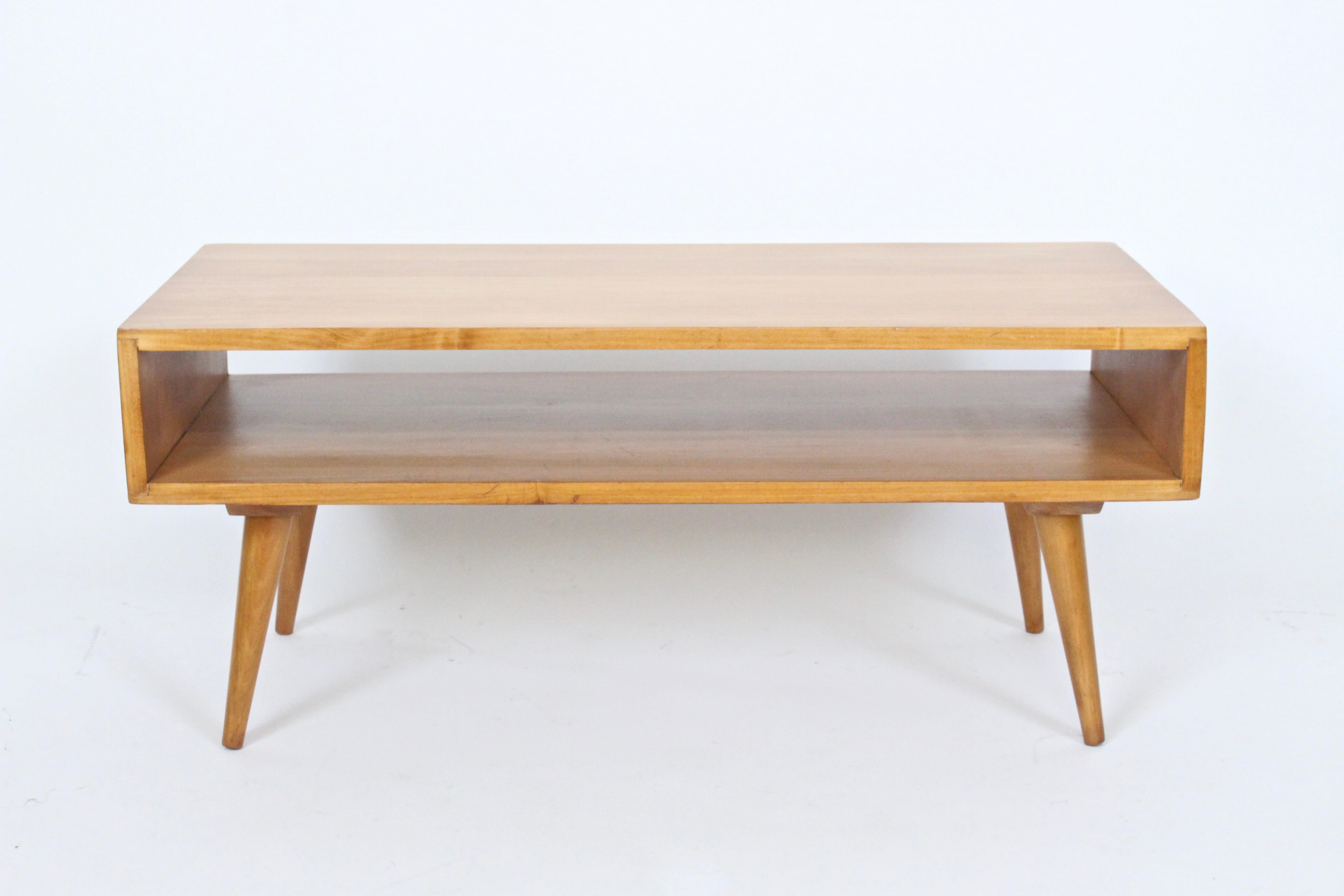 Early 1950's Marc Berge, Grosfeld House attributed, solid maple two-tier coffee table - bench. Featuring rectangular construction with lap joints, wooden screw dowel legs. Storage area 4.75 H. Former Paul McCobb Associate. Compact. Wide storage.