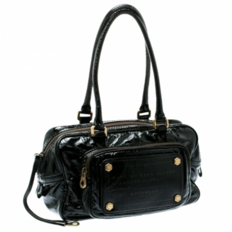 This satchel by Marc by Marc Jacobs will surely fetch you a lot of compliments. The satchel is crafted from laminated leather and comes with dual handles. The exterior of the bag flaunts a zip pocket on the front and back. The zip top closure