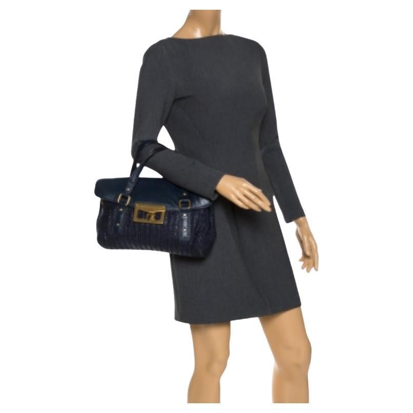Questa borsa con patta della casa Marc by marc jacobs è qualcosa che vorresti indossare stagione dopo stagione. È stata realizzata con un corpo in paglia blu e presenta una patta frontale in pelle. È dotata di due manici piatti e di una serratura