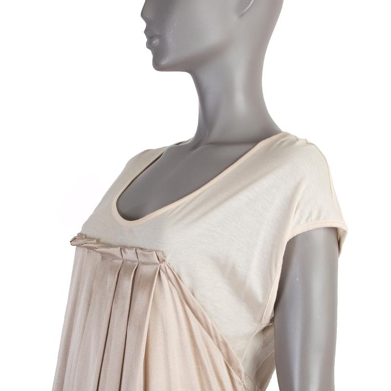 100% authentic Marc by Marc Jacobs cap-sleeve shift dress in light vanilla supima cotton (55%) and modal (45%) and champagne silk ((54%), cotton (41%), and spandex (4%). With pleats on the front and back. Has been worn and is in excellent condition.