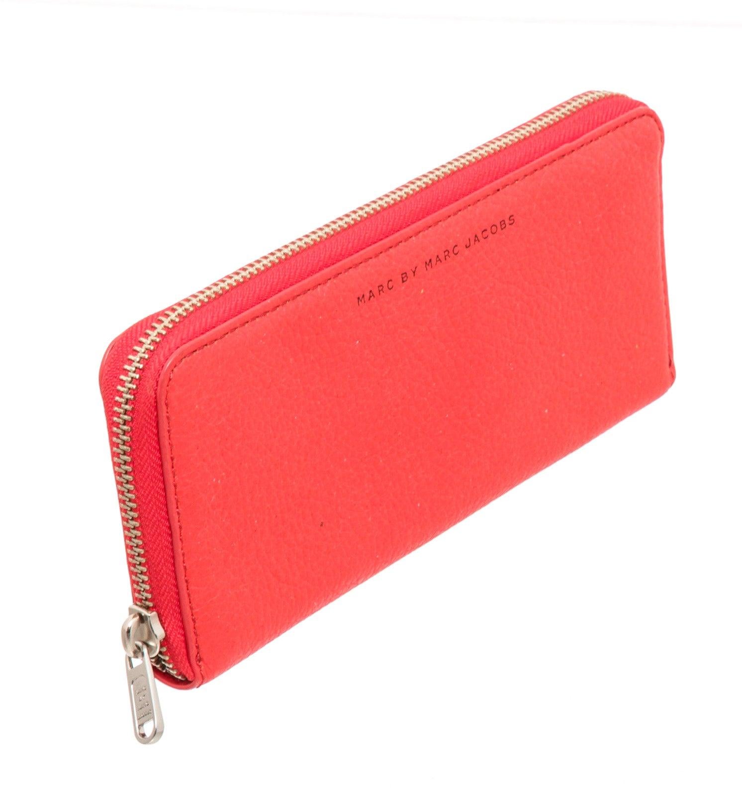 Marc By Marc Jacobs red leather zippy wallet with Silver-tone hardware, red leather interior lining, five interior pockets; one with zip closure, eight card slots and overall zip around closure.  25204MSC