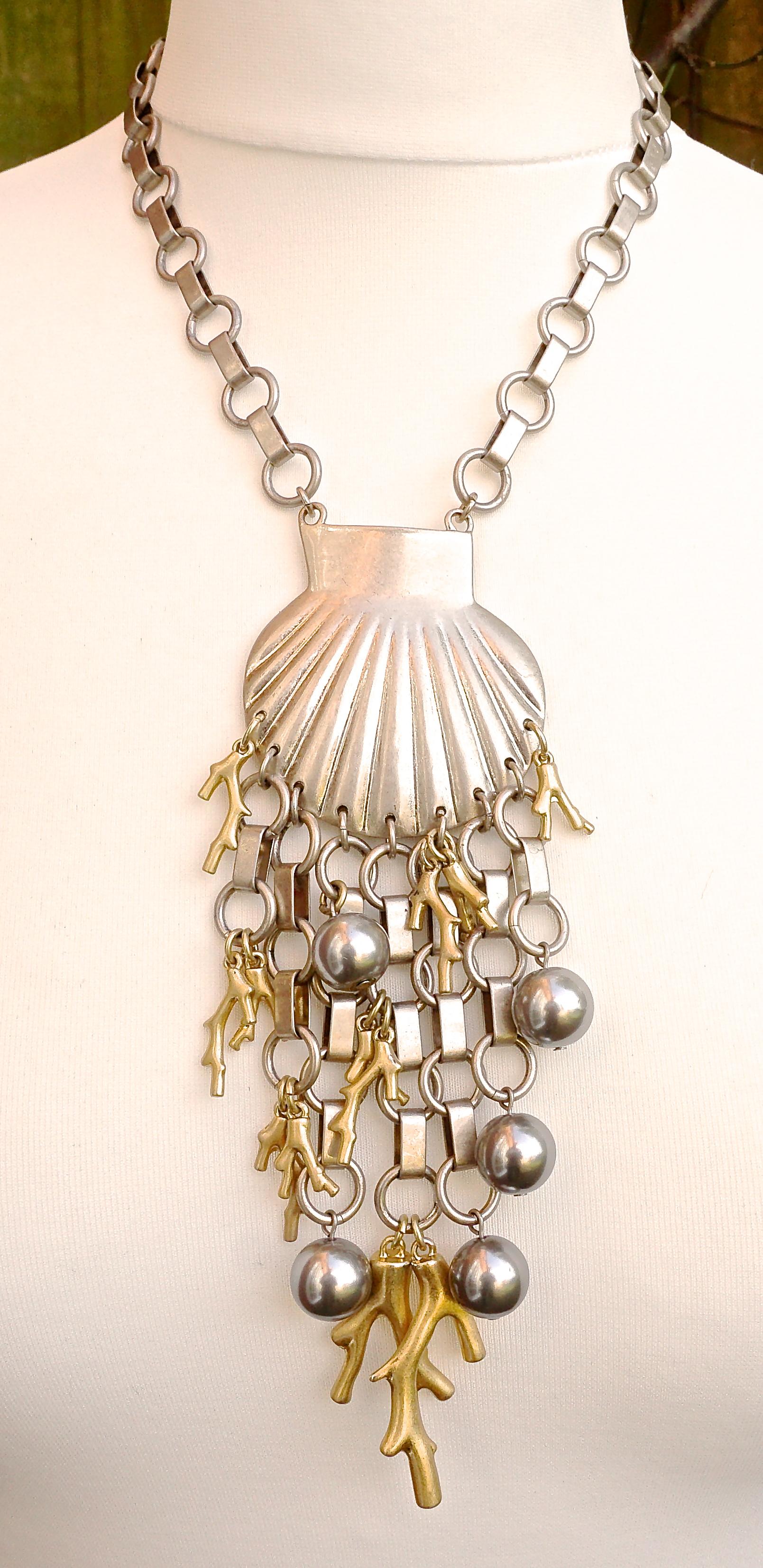 Marc by Marc Jacobs silver plated and gold plated pendant necklace featuring a large silver seashell with an underwater design comprising silver chain, silver ball and gold coral drops. The necklace is length 46.2cm / 18.19 inches, and the pendant