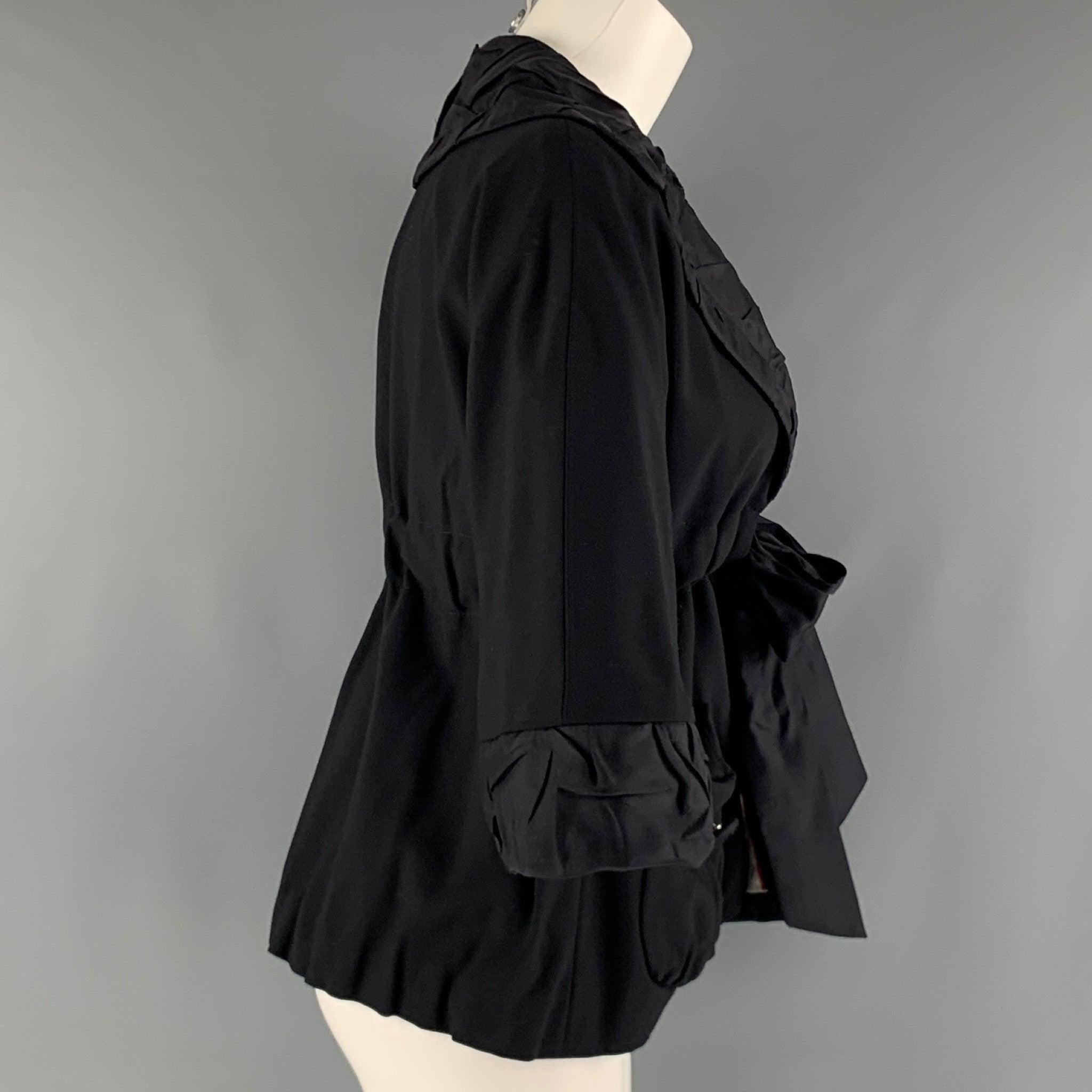 MARC by MARC JACOBS jacket comes in a black viscose blend woven material featuring a notch textured collar, 3/4 sleeves, patch pockets at front, and a ribbon tie closure. Excellent Pre-Owned Condition. 

Marked:   2 

Measurements: 
 
Shoulder: 16