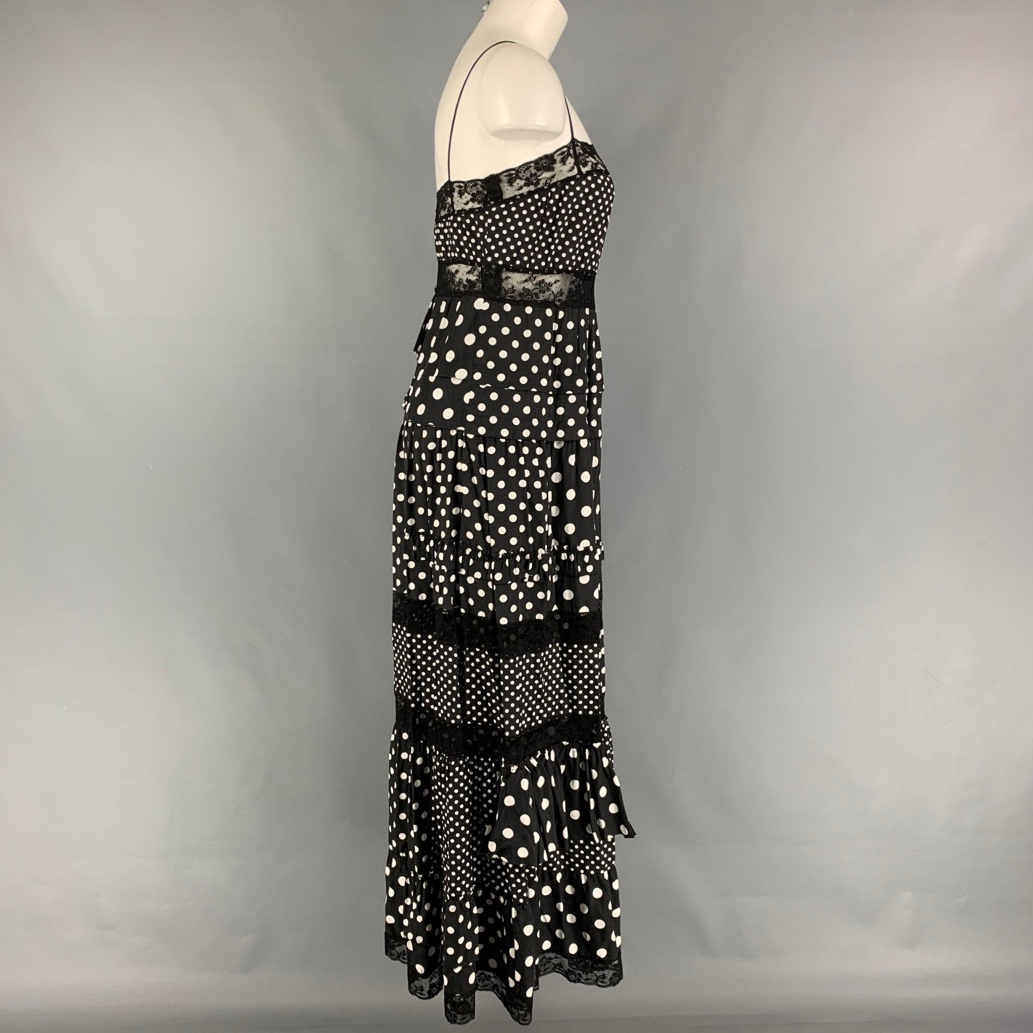 MARC by MARC JACOBS dress comes in a black & white polka dot viscose featuring a ruffled style, lace trim, and spaghetti straps.
Very Good
Pre-Owned Condition. 

Marked:   2 

Measurements: 
  Bust: 30 inches  Waist: 30 inches  Hip: 40 inches 