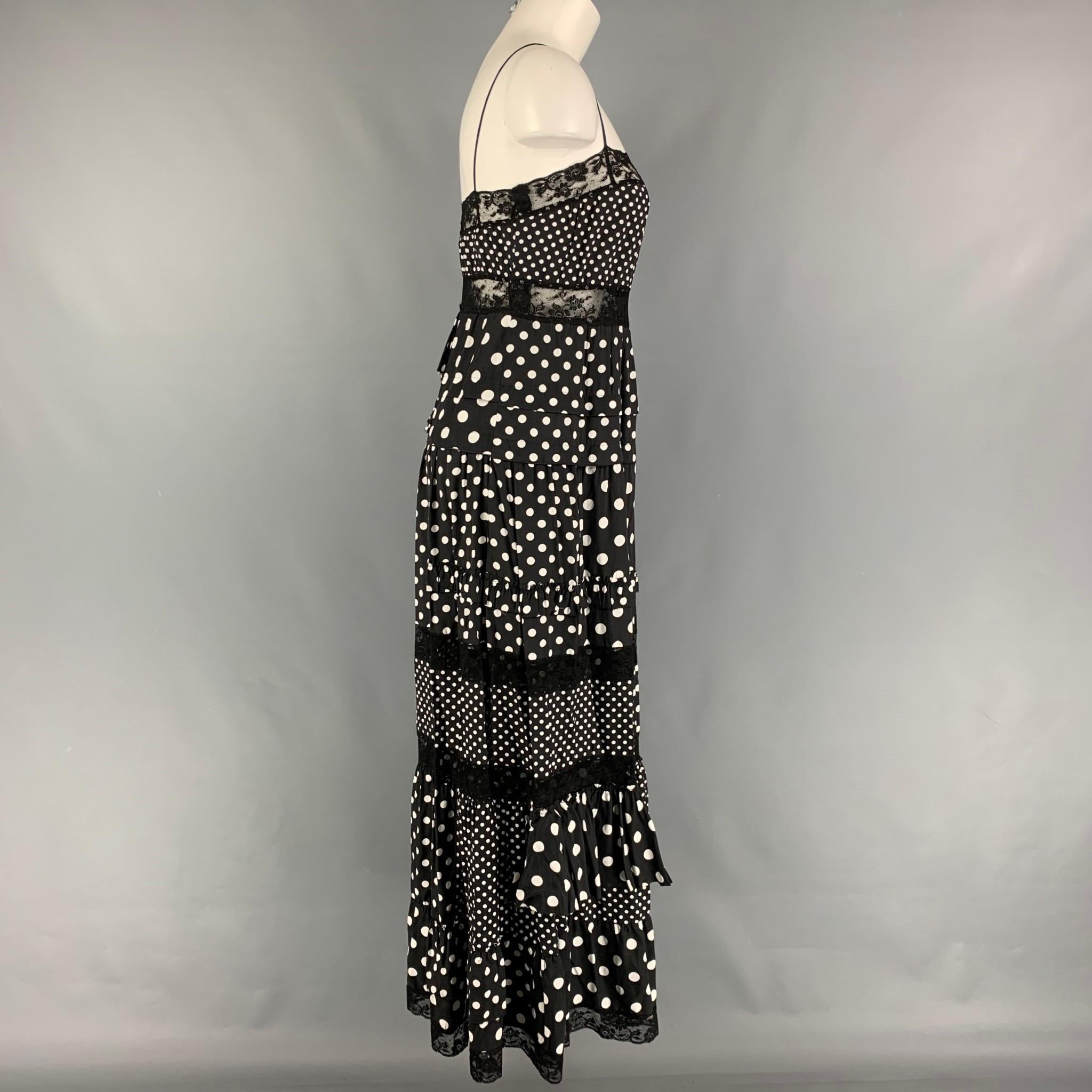 MARC by MARC JACOBS dress comes in a black & white polka dot viscose featuring a ruffled style, lace trim, and spaghetti straps. 

Very Good Pre-Owned Condition.
Marked: 2

Measurements:

Bust: 30 in.
Waist: 30 in.
Hip: 40 in.
Length: 46 in. 