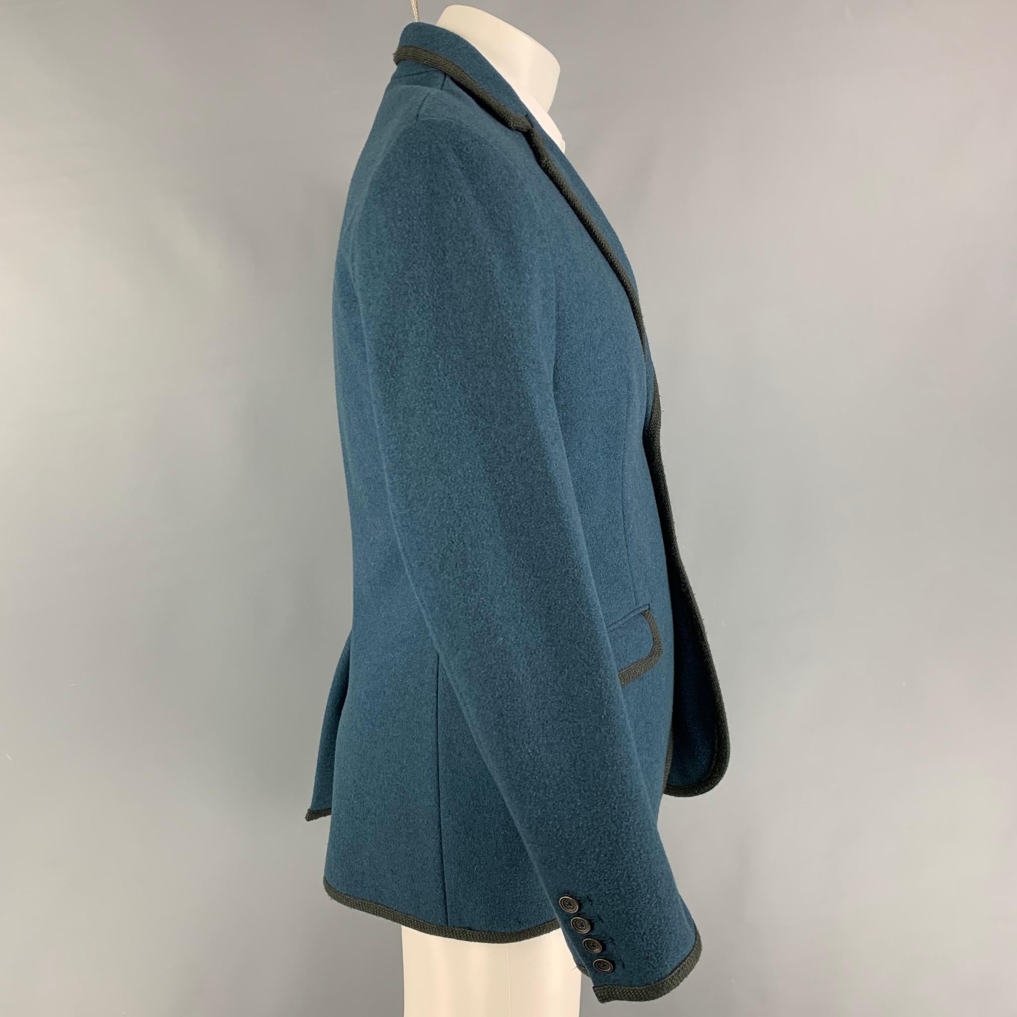 MARC by MARC JACOBS sport coat comes in a teal & charcoal wool with a full liner featuring a notch lapel, flap pockets, single back vent, and a double button closure. 

Very Good Pre-Owned Condition.
Marked: M

Measurements:

Shoulder: 18.5