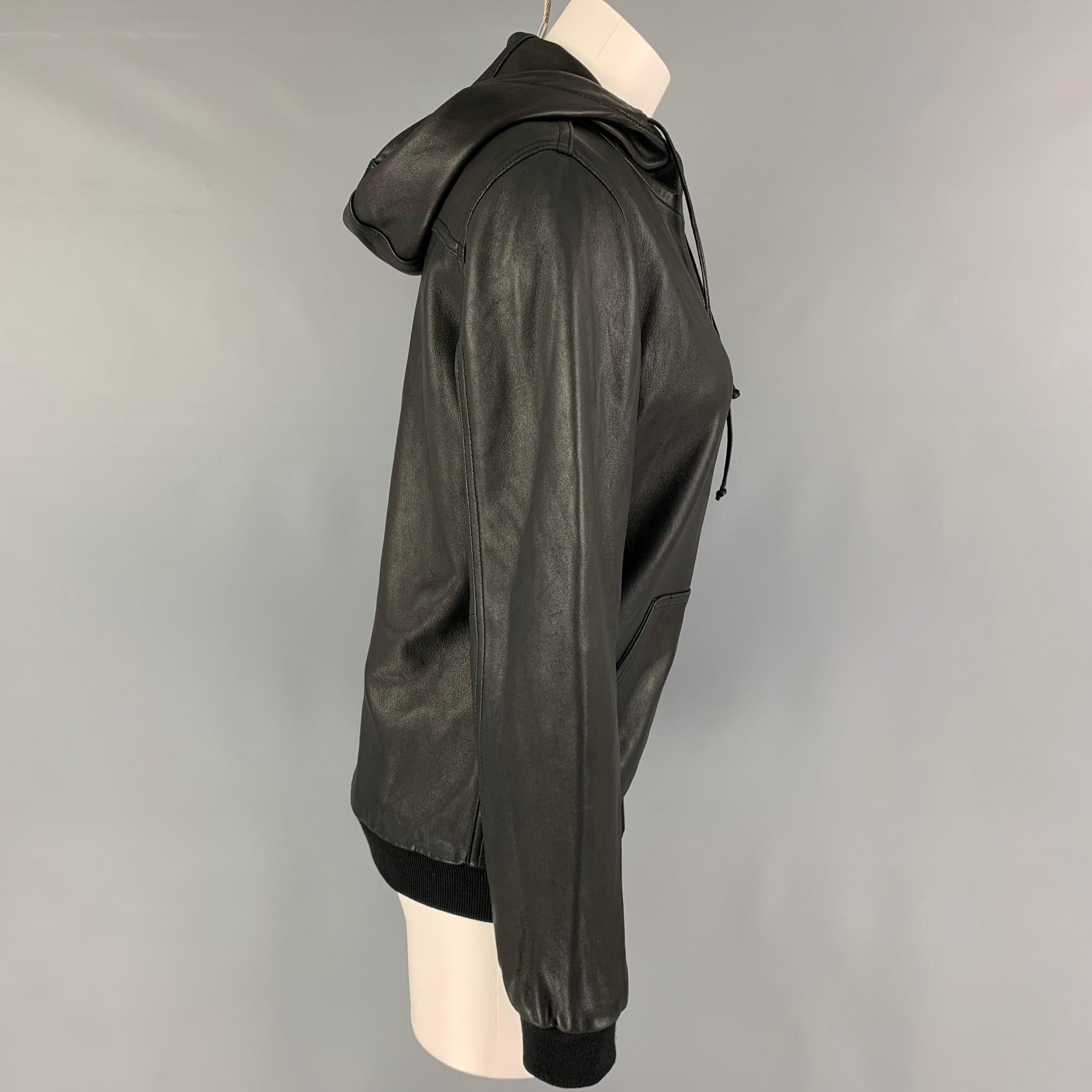 MARC by MARC JACOBS jacket comes in a black leather featuring a hooded style, ribbed hem, front pocket, and a full zip up closure. 

Excellent Pre-Owned Condition.
Marked: S

Measurements:

Shoulder: 16 in.
Bust: 36 in.
Sleeve: 24.5 in.
Length: 24.5