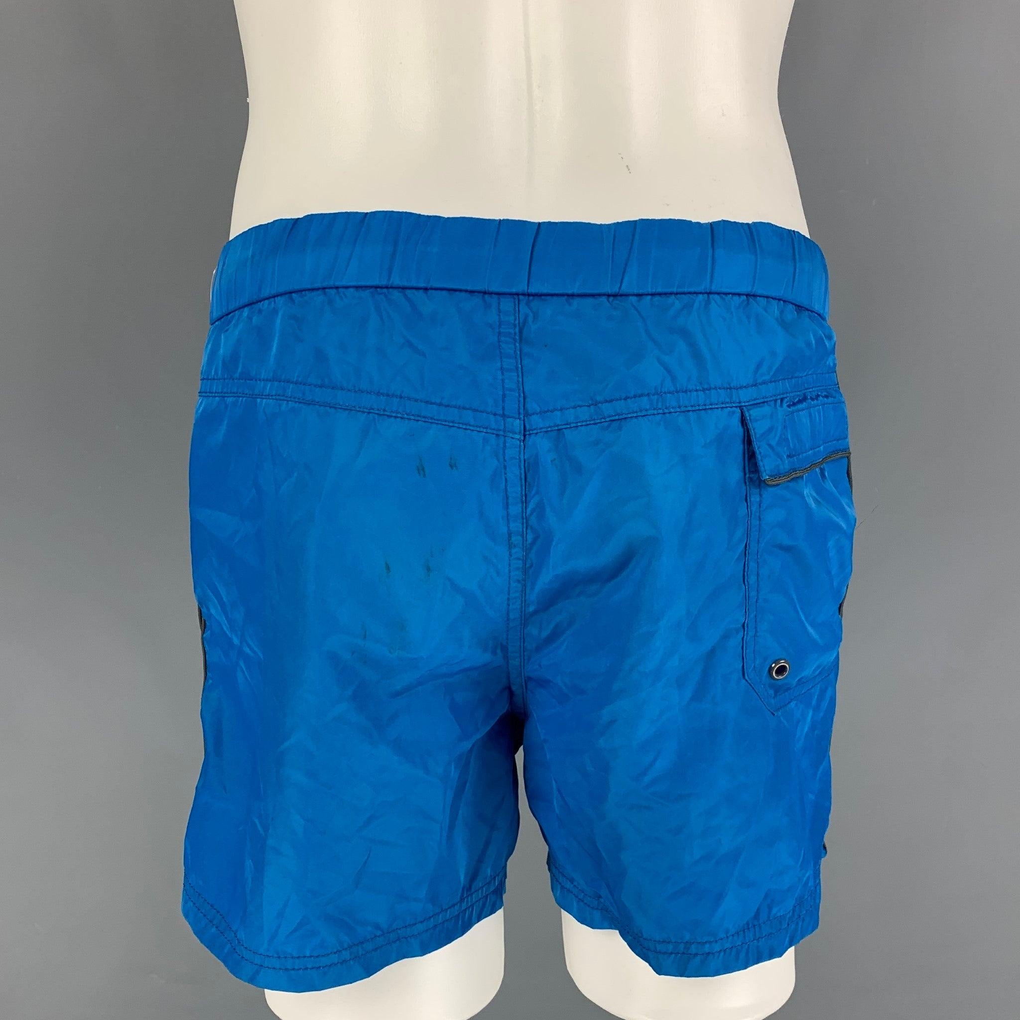 MARC by MARC JACOBS swim trunks comes in a blue polyester with a mesh liner featuring a drawstring, zip fly, and a snap button closure.
Good
Pre-Owned Condition. Light marks at back  

Marked:   S 

Measurements: 
  Waist: 30 inches  Rise: 10.5