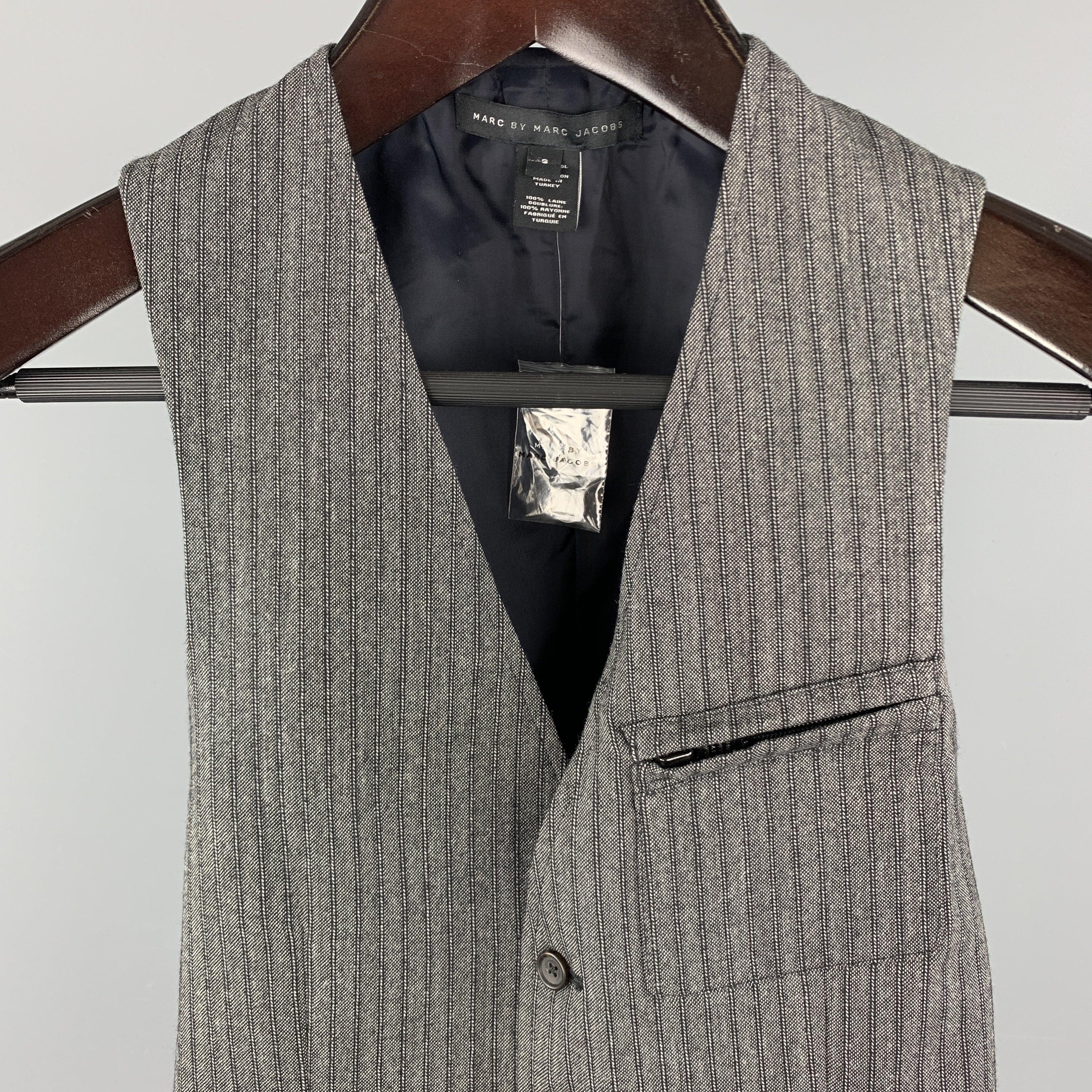 MARC by MARC JACOBS Vest comes in a gray stripe wool material, with a V-neck, a buttoned front, zip and slit pockets, and a striped back.New without Tags. 

Marked:   S 

Measurements: 
 
Shoulder: 11.5 inches 
Chest:
34 inches 
Length:
 24 inches 
