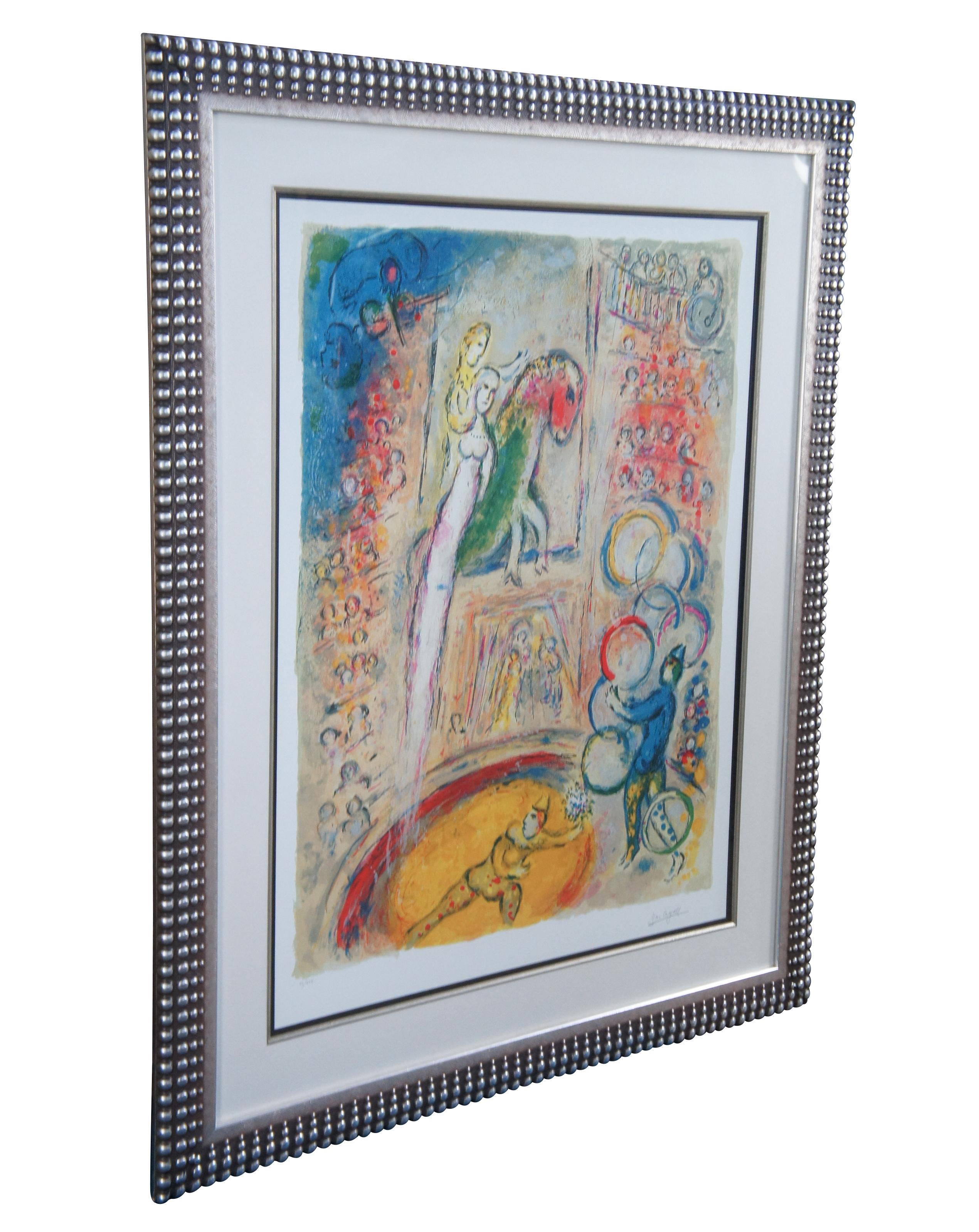 Vintage large and impressive Marc Chagall impressionist/expressionist lithograph on paper featuring a circus scene with a man, woman / angel and horse levitating above the crowd with a pair of juggling clowns. Beautifully framed in a coin dot /