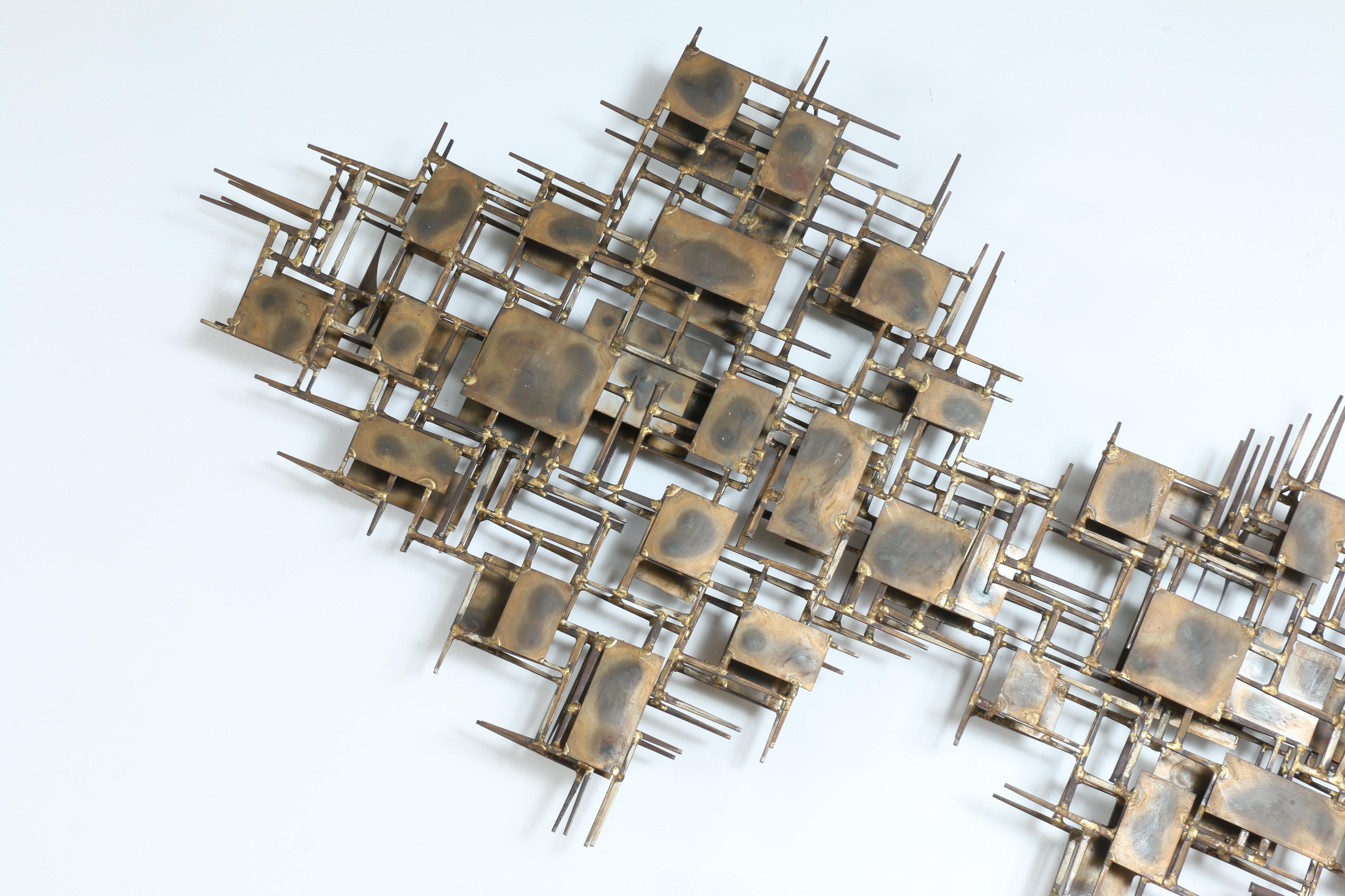 Marc Creates Metal wall sculpture with original patina. Defined with brass squares and pointy edges. In good condition with no dents or scratches. Signed by Marc Creates.