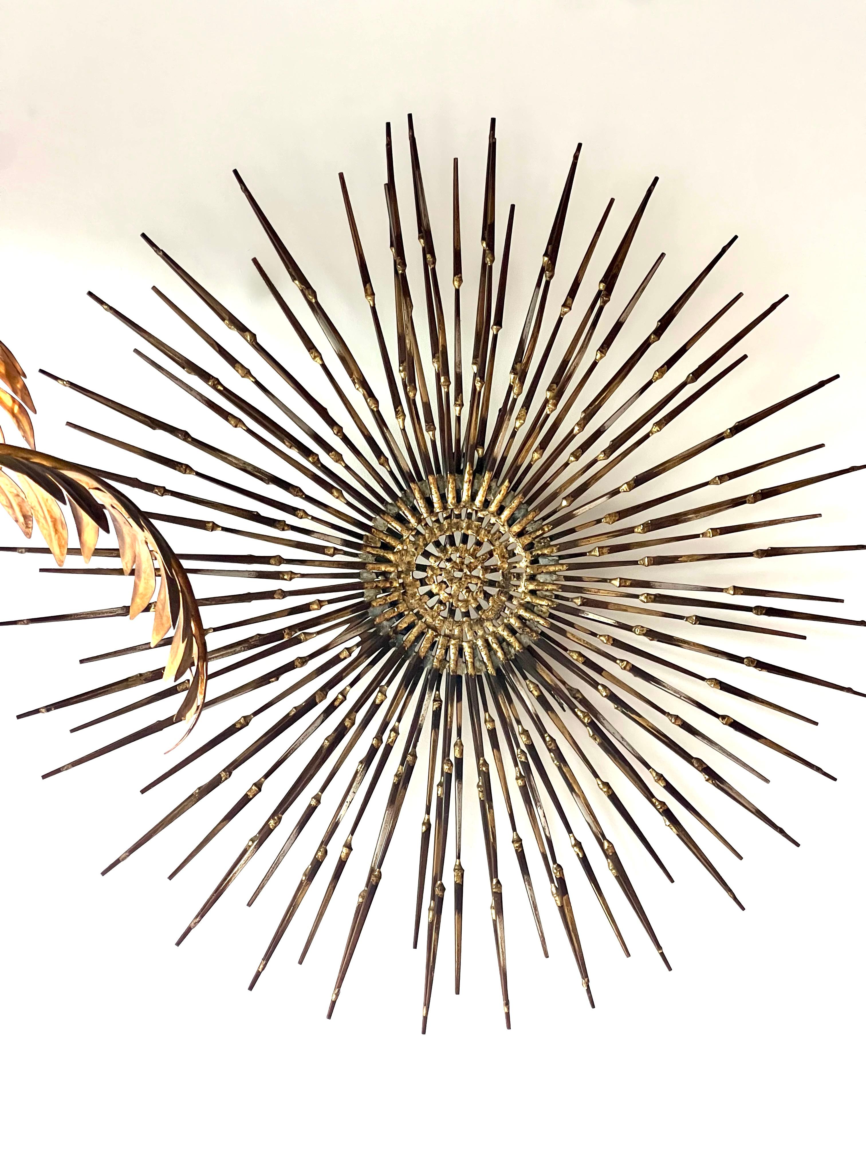 Crafted by Marc Weinstein in 1974, this piece features intricate layers of brass and steel, arranged in a radiant, sunburst composition that evokes energy and movement.

Hand-forged and meticulously assembled, 