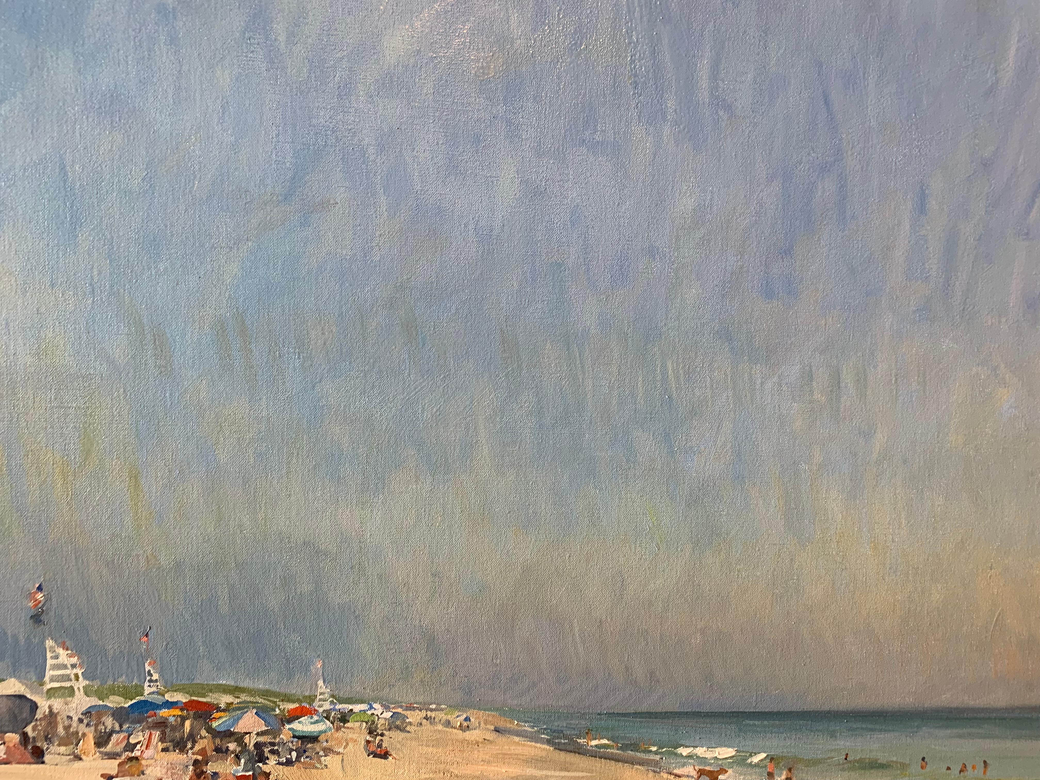 Painted en plein air, in Amagansett, New York. Indian Wells Beach is a bustling shoreline in East Hampton. Figure rest under umbrellas, and on towels, on this vast expanse of sand. A lifeguard stand sits tall in the distance amongst the crowd.