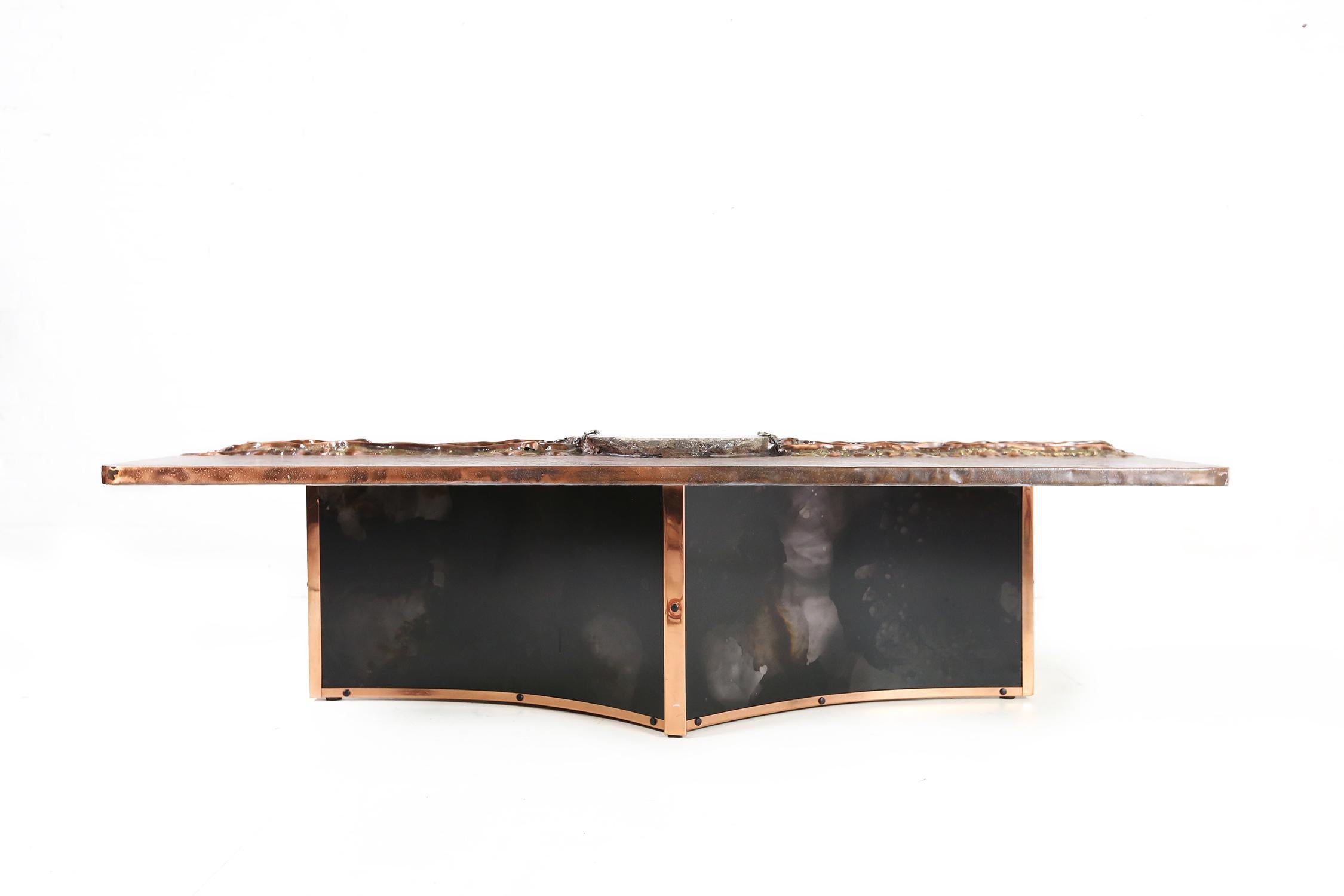 Impressive sculptural coffee table designed by the Belgian artist and designer Marc D’Haenens in the 1980s.
It is a unique piece of furniture with a copper top engraved and decorated with an lepidolite stone (31cm L)
This piece of art is signed on
