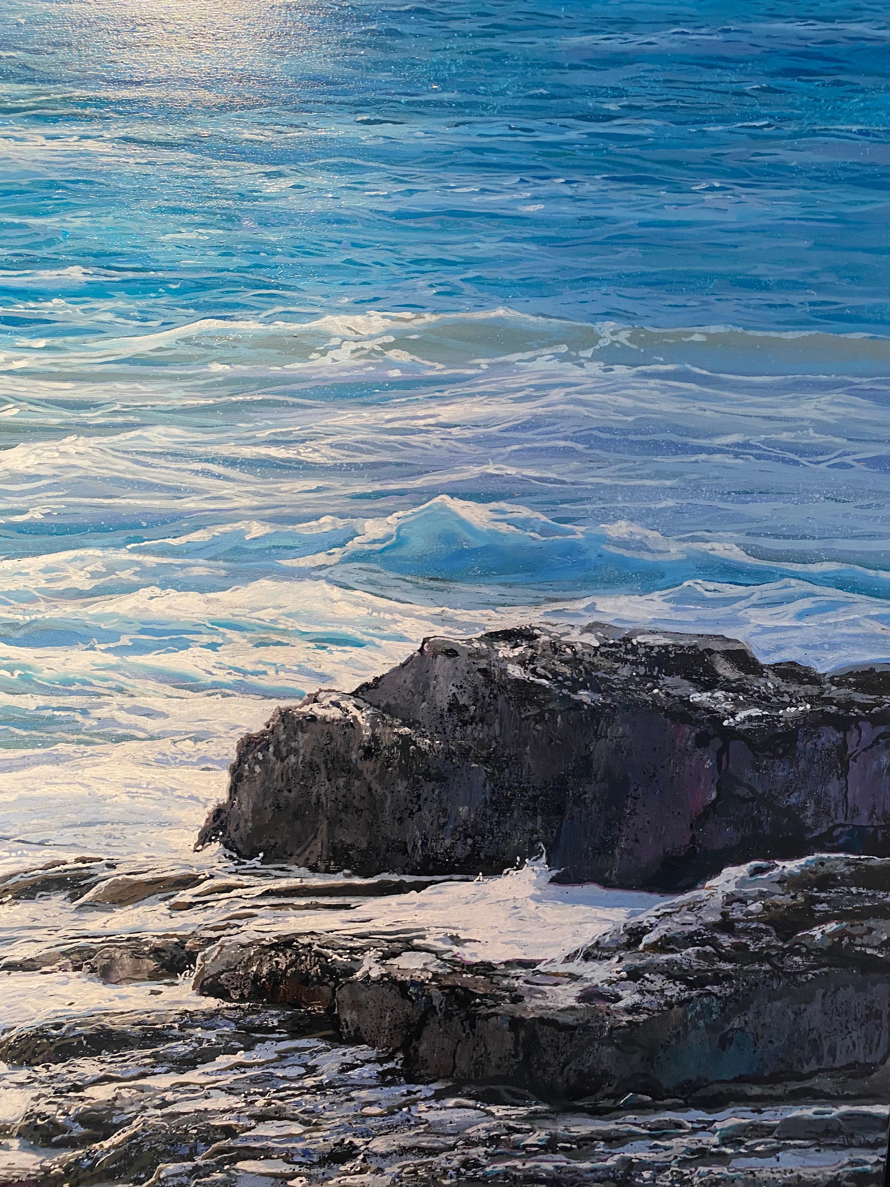 'Blue Vista' Contemporary Seascape painting of rocks, blue skies, sunlit water - Photorealist Painting by Marc Esteve