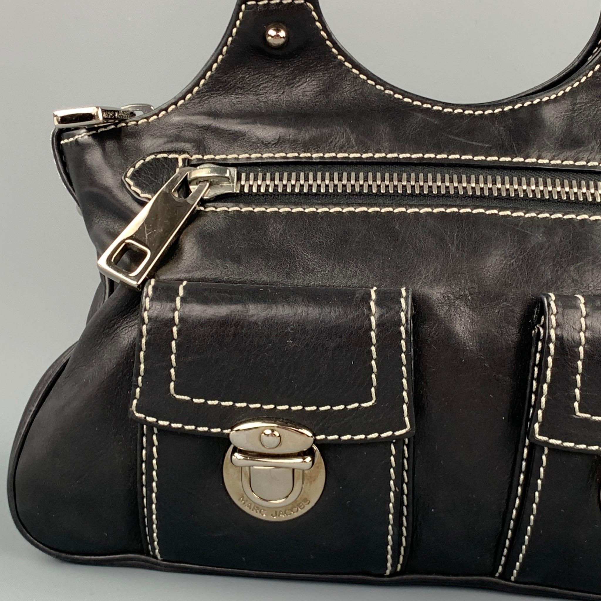MARC JACOBS handbag comes in a black leather with contrast stitching featuring top handles, silver tone hardware, front pockets, zipper pocket, and a top zip up closure. 

Very Good Pre-Owned Condition.

Measurements:

Length: 11 in. 
Width: 2.5 in.
