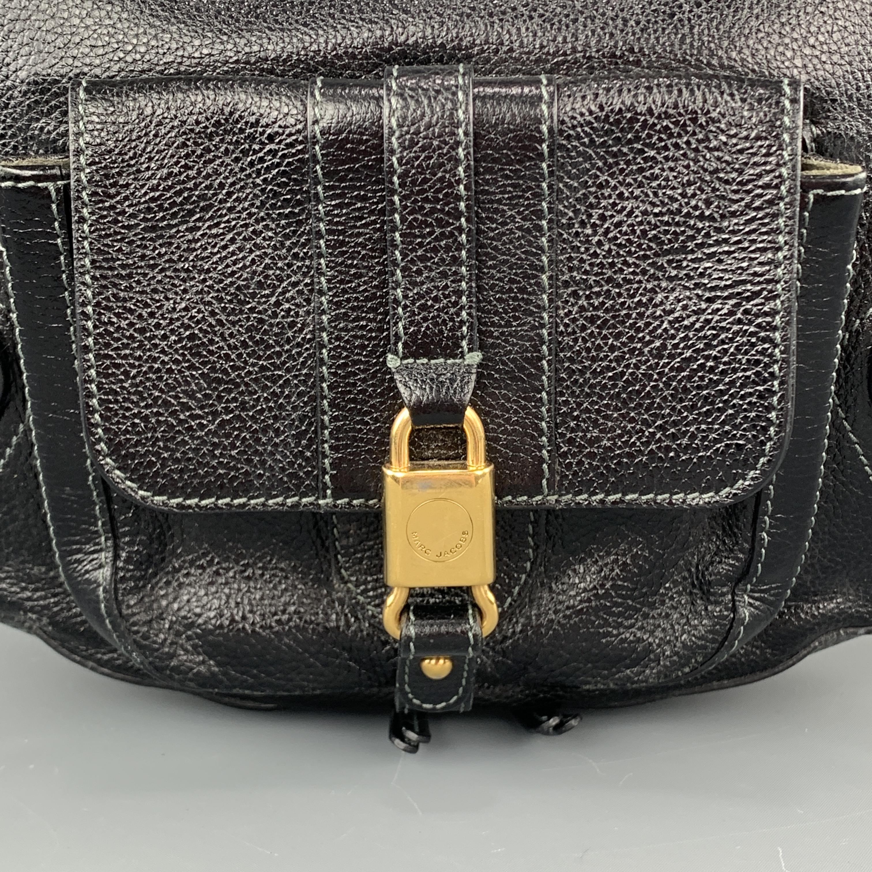 MARC JACOBS hobo bag comes in black textured patent leather with flap pocket, gol tone zips and lock hardware, and single shoulder strap. Made in Italy.

Very Good Pre-Owned Condition.

Measurements:

Length:15.75 in.
Width: 3 in.
Height: 12
