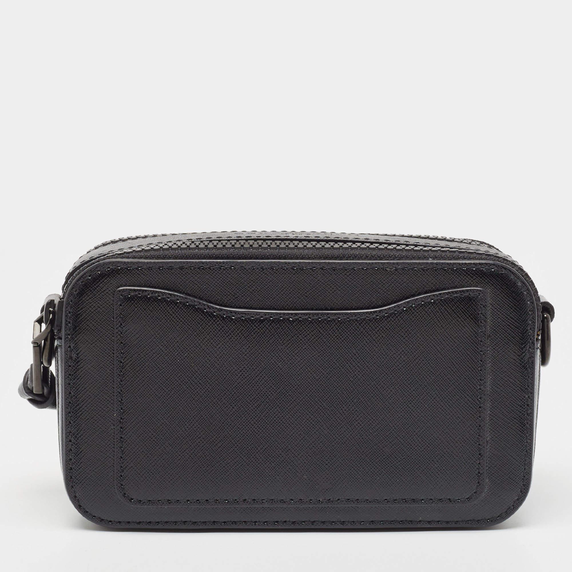 Structured, sophisticated, and stylish are some words that describe this Snapshot crossbody bag! Crafted from best quality material, the creation is adorned with the label's signature appeal, held by comfortable handles, and equipped with a