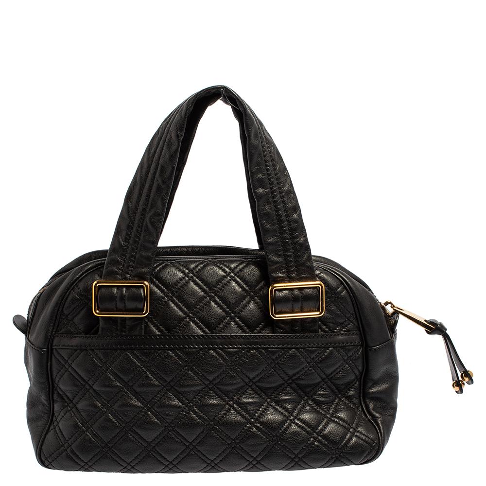 This Marc Jacobs Ursula bowler bag is made from quilted black leather. It features an engraved push-lock detail on the front and twin handles. The interior is lined with canvas and houses a patch pocket and a Marc Jacobs label.

Includes: Original