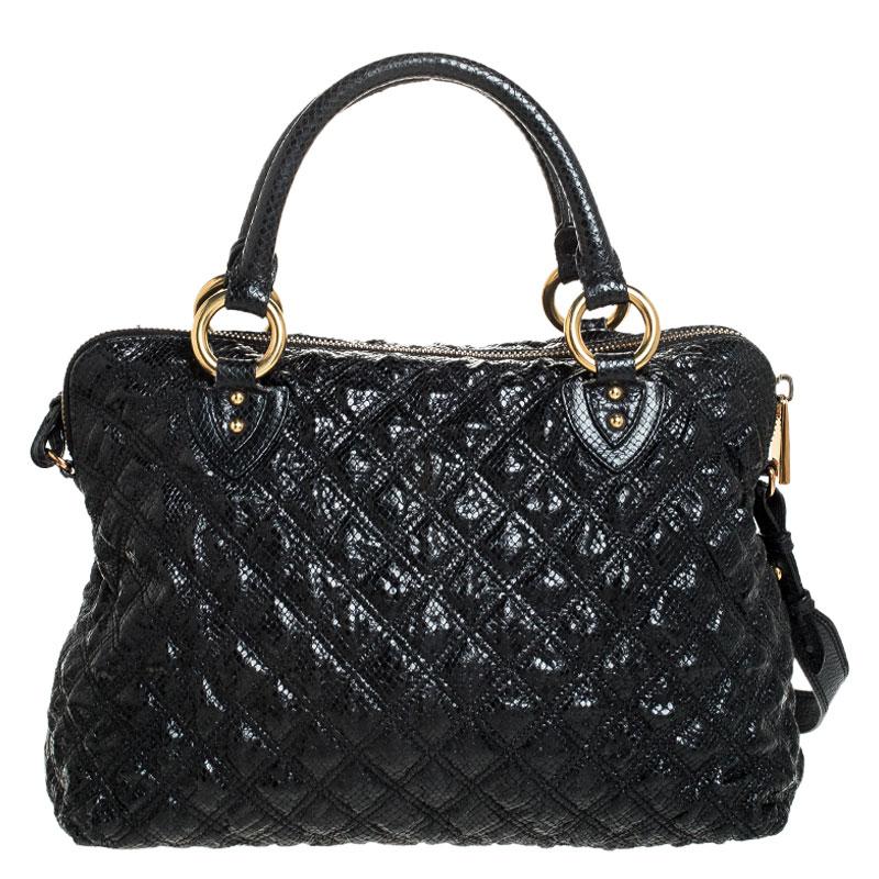 For all the Marc Jacobs fans out there, your search for that perfect handbag ends here. Fluidly glide from day to night with this all-around leather tote that offers a spacious design. This classic black bag is enhanced with snakeskin embossment and