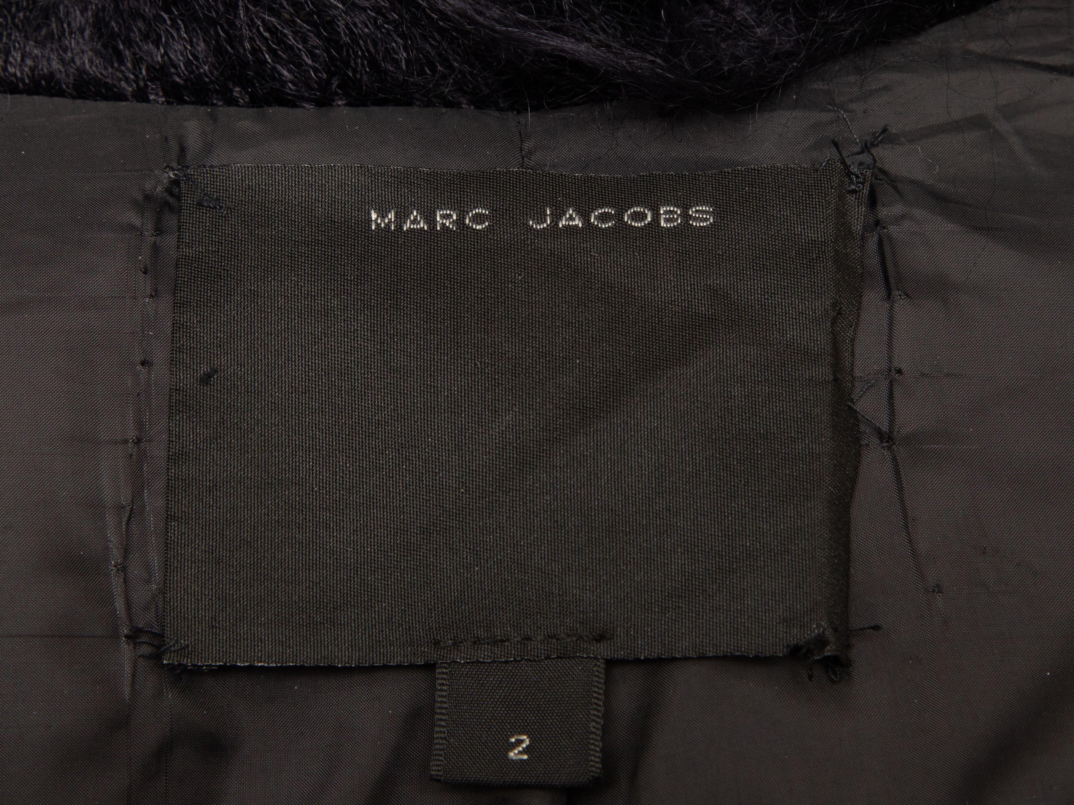 Product Details: Vintage black shaggy faux fur coat by Marc Jacobs. Notched collar. Dual hip pockets. Button closures at center front. 34