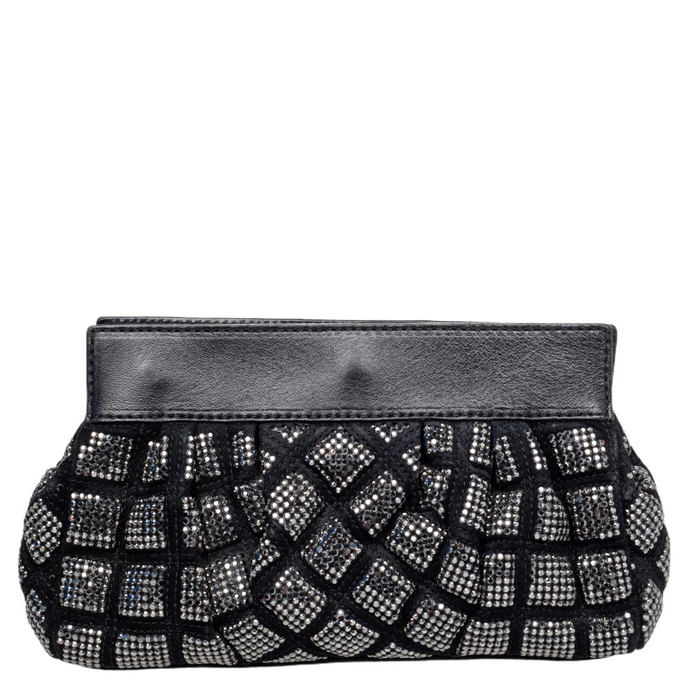 This eye-catching clutch by Marc Jacobs is crafted from suede & leather and beautifully detailed with studs on the exterior. It has a turn-lock closure that opens to a leather & satin interior where you can store your basic essentials. It's a