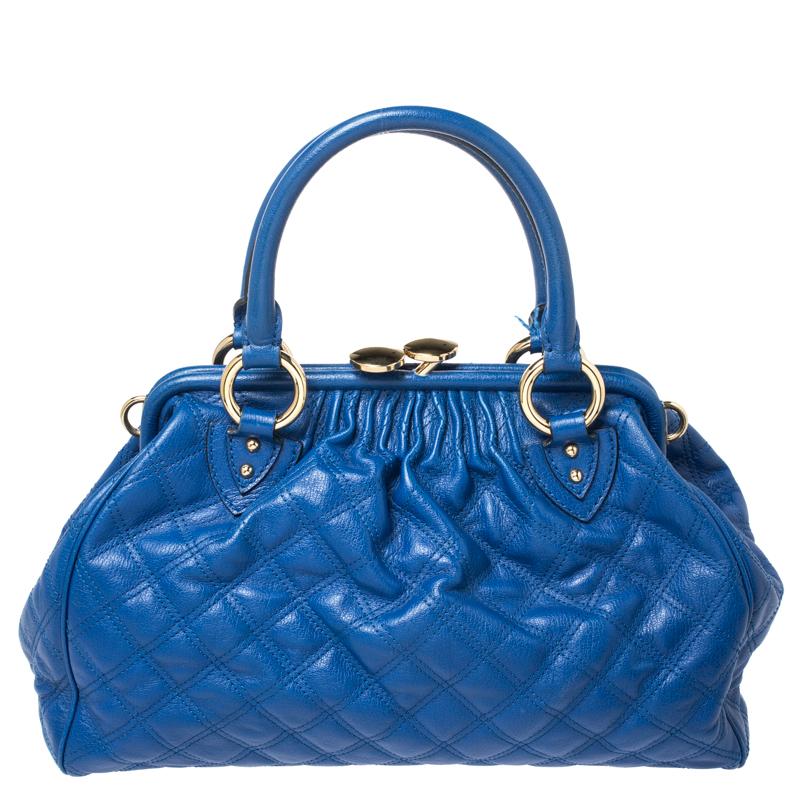This Marc Jacobs design has a blue quilted exterior crafted from leather and enhanced with gold-tone hardware. This elegant Stam bag features a kiss-lock top closure that opens to a fabric interior, dual top handles and a removable chain that