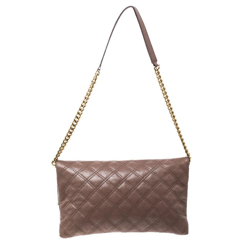 Covered in a timeless quilted pattern, this Eugenie clutch by Marc Jacobs comes in a flap style. It has a brown leather body with a padlock in gold tone on the flap, a canvas interior with a zip pocket and a chain with a leather shoulder