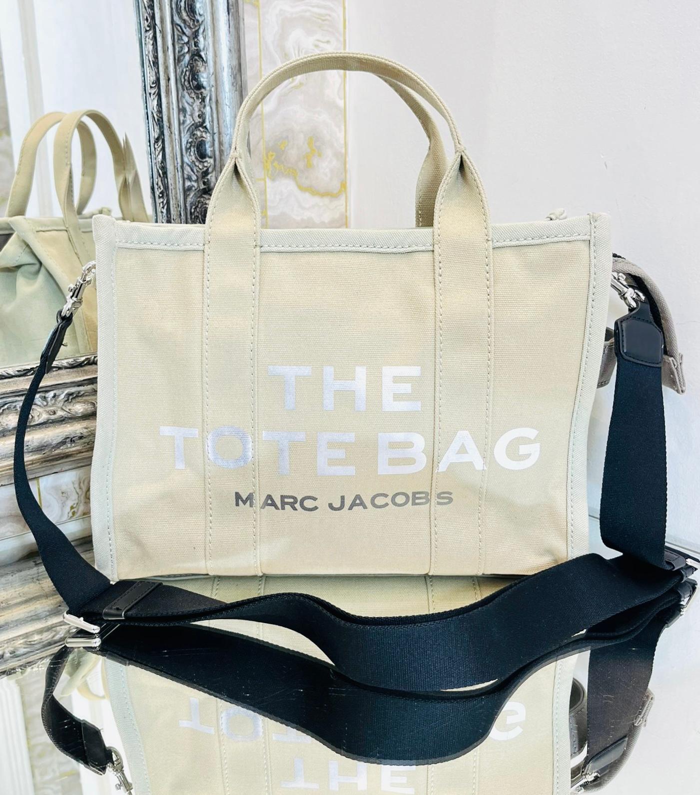 Marc Jacobs Canvas Tote Bag

Beige rectangle shaped tote bag designed with white 'The Tote Bag' inscription to the front.

Featuring dual top handle and detachable, adjustable black shoulder strap.

Styled with top zip closure leading to spacious