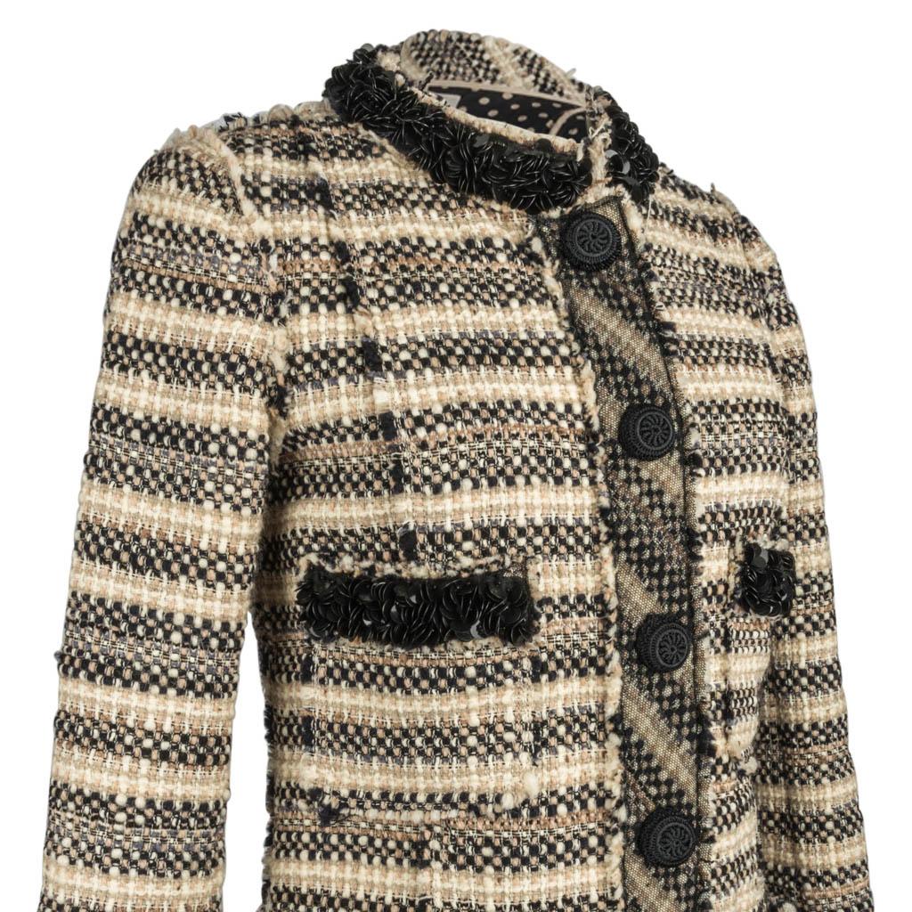 Marc Jacobs divine tweed coatwith a variety of beautiful details. 
Terrific texture with bone, beige, black and shades of gray.
The cuffs, neck and pockets are trimmed in lush black paillettes. 
The effect is superb.
Five large black crocheted