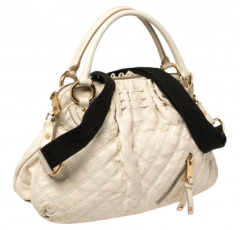 A functional design, unique details, and timeless appeal make this Cecilia satchel from Marc Jacobs a worthy addition to any women's closet. Crafted from cream quilted leather, it has been styled with a zip detailing on the front. A zip-top closure