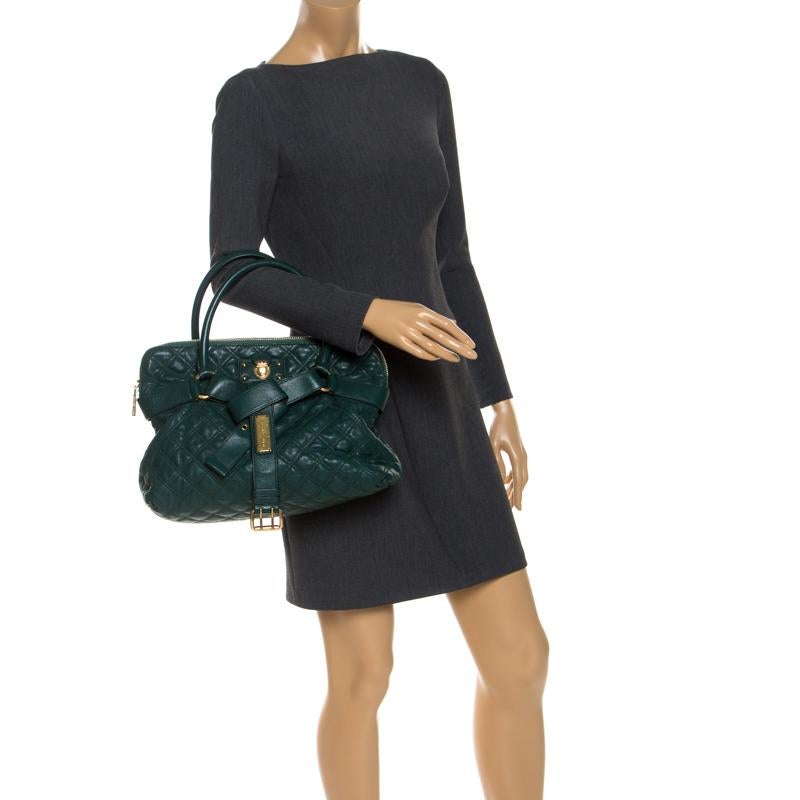 This Marc Jacobs Bruna tote is stunning ad deliver sophistication. It is made from quilted leather and comes in a lovely shade of dark green. It has a belt accent, dual rolled top handles, a spacious interior lined with fabric and a zip closure. The