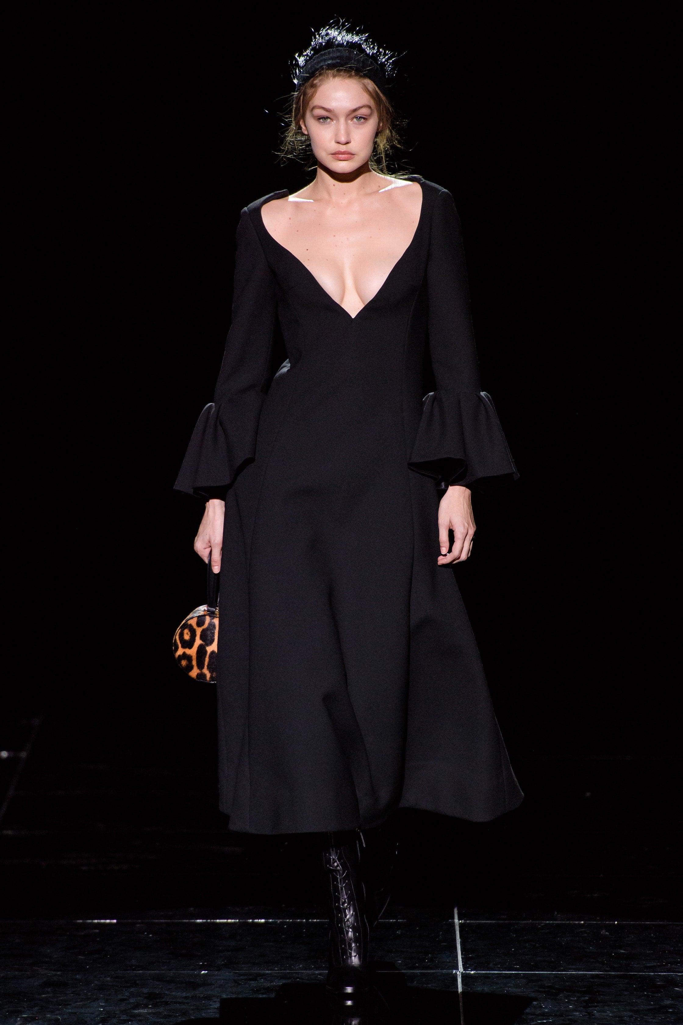 MARC JACOBS Fall-Winter 2019 dress comes in a black wool blend featuring a deep v-neck, a-line style, ruffled sleeves, and a back zipper closure. Seen on Gigi Hadid. Made in USA.
Excellent
Pre-Owned Condition. 

Marked:   2 

Measurements: 
  Bust: