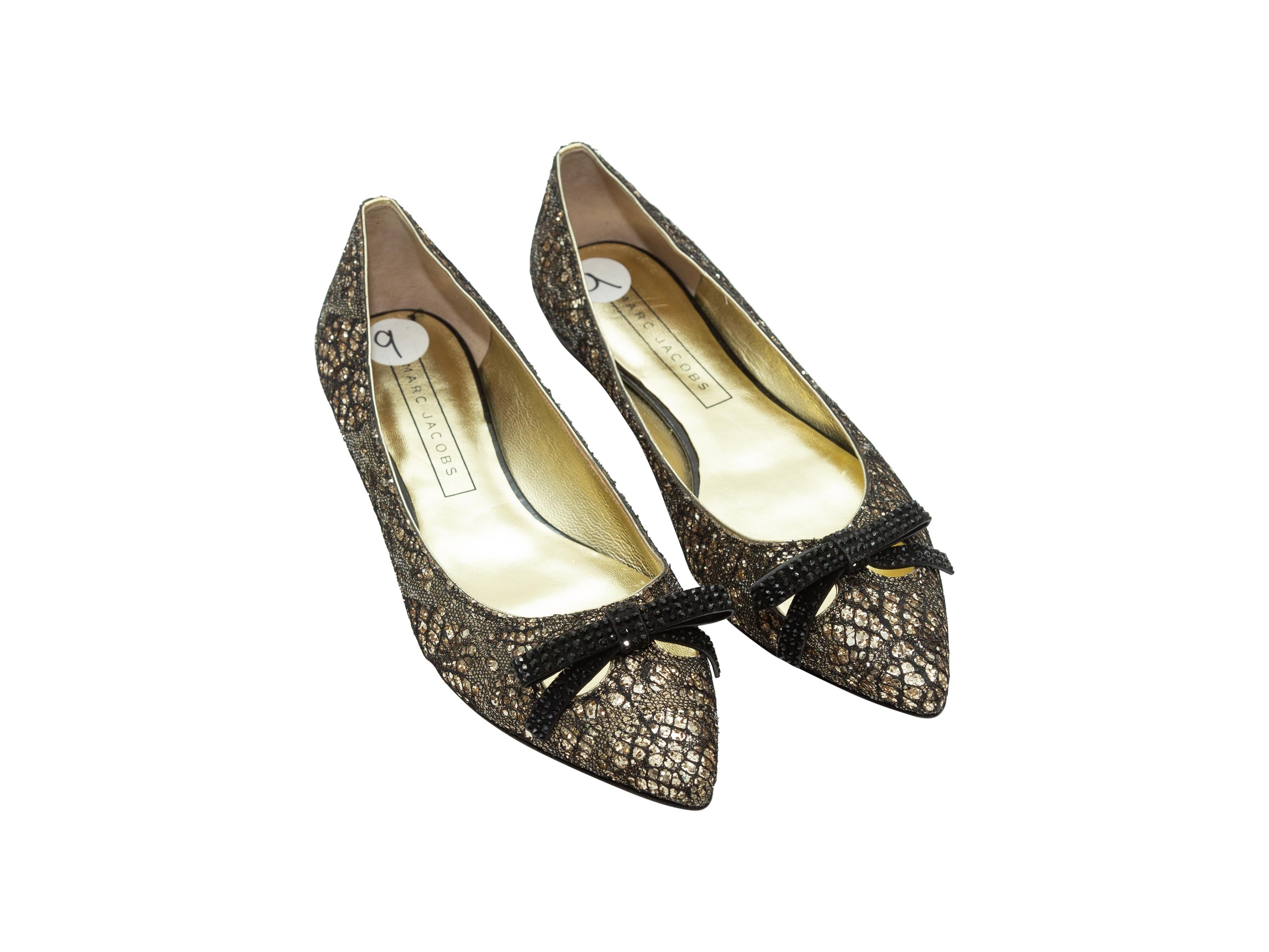 Product details: Gold and black metallic lace pointed-toe flats by Marc Jacobs. Bow embellishments at tops. Designer size 39.
Condition: Pre-owned. Excellent.