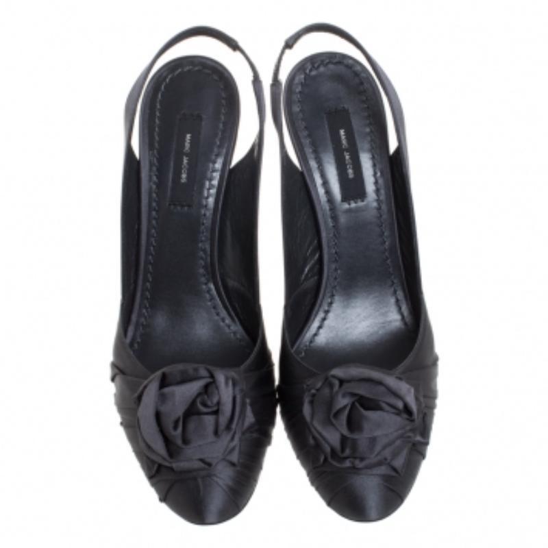 Slip into these Marc Jacobs sandals and add grace to your strides. Crafted from black satin, they are held by slingbacks. With round toes, rose details and 9.5 cm heels, these sandals will give a feel of luxury to your feet.