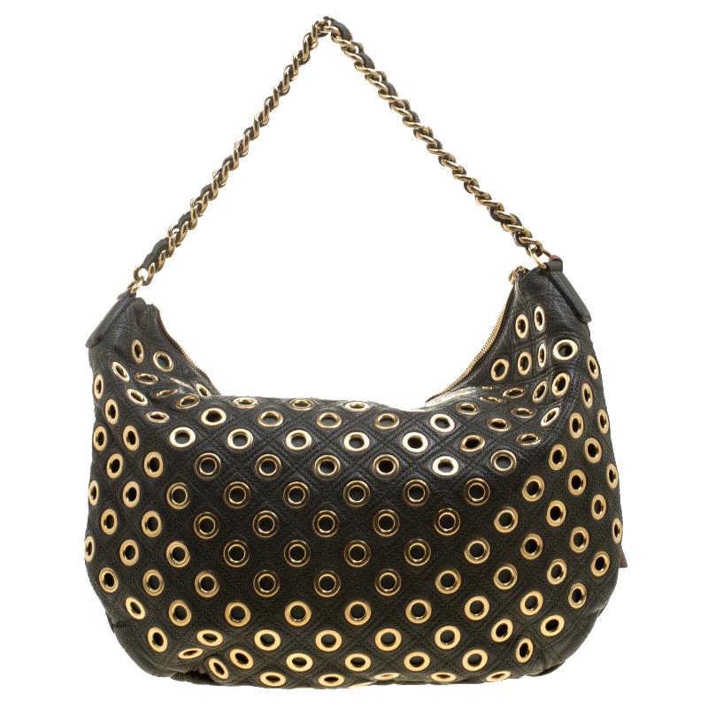 Handbags are more than just style statements. That's why one should opt for pieces that are functional and stylish at the same time, just like this shoulder bag from Marc Jacobs. Created from leather, the bag has eyelets details all over and it