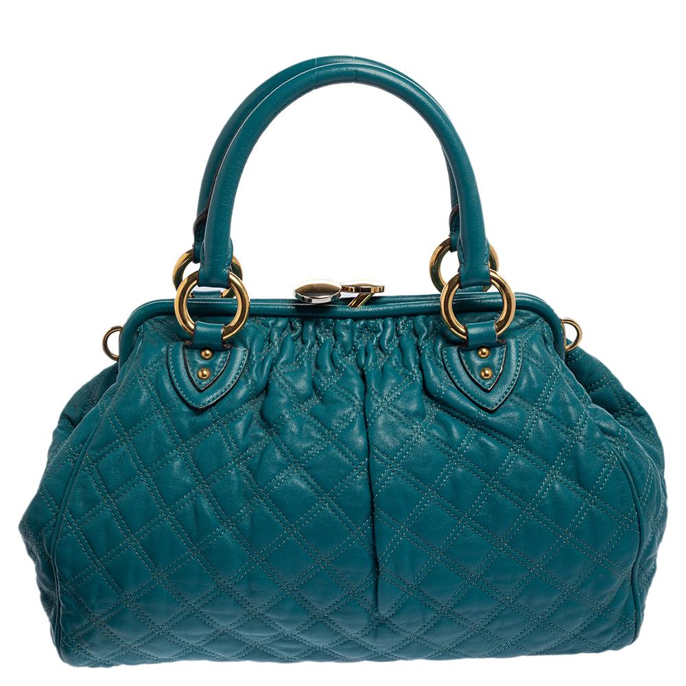 This Marc Jacobs design has a green exterior crafted from leather and enhanced with gold-tone hardware. This elegant Stam bag features a kiss-lock top closure that opens to a canvas interior, dual top handles, and a removable chain that converts