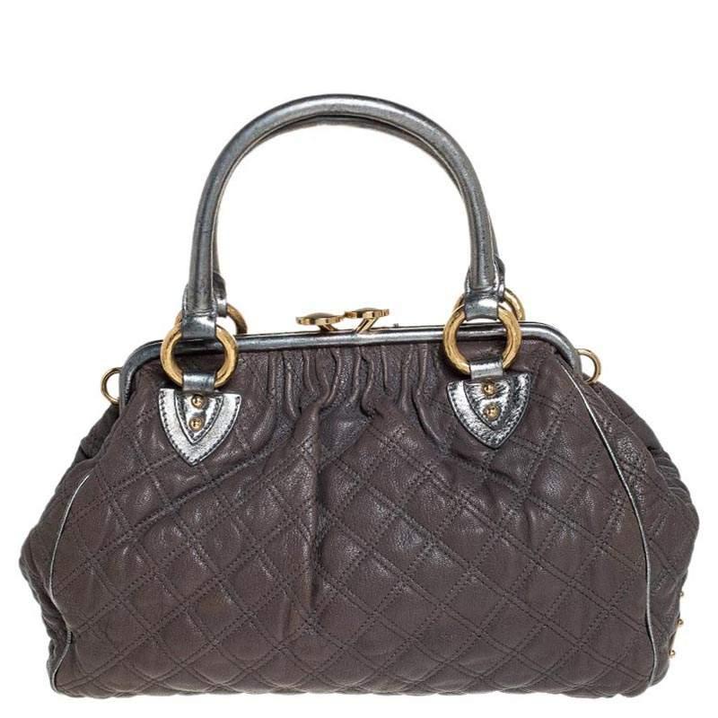 This Marc Jacobs design has a grey quilted exterior crafted from leather and enhanced with gold-tone hardware. This elegant Stam bag features a kiss-lock top closure that opens to a fabric interior and dual top handles. Swing this beauty wherever