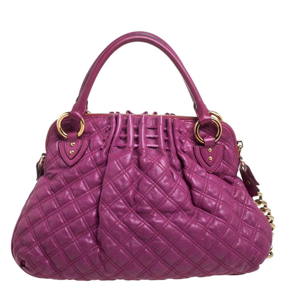 A functional design, unique details, and timeless appeal make this Cecilia satchel from Marc Jacobs a worthy addition to any women's closet. Crafted from magenta quilted leather, it has been styled with zip detailing on the front. A zip-top closure