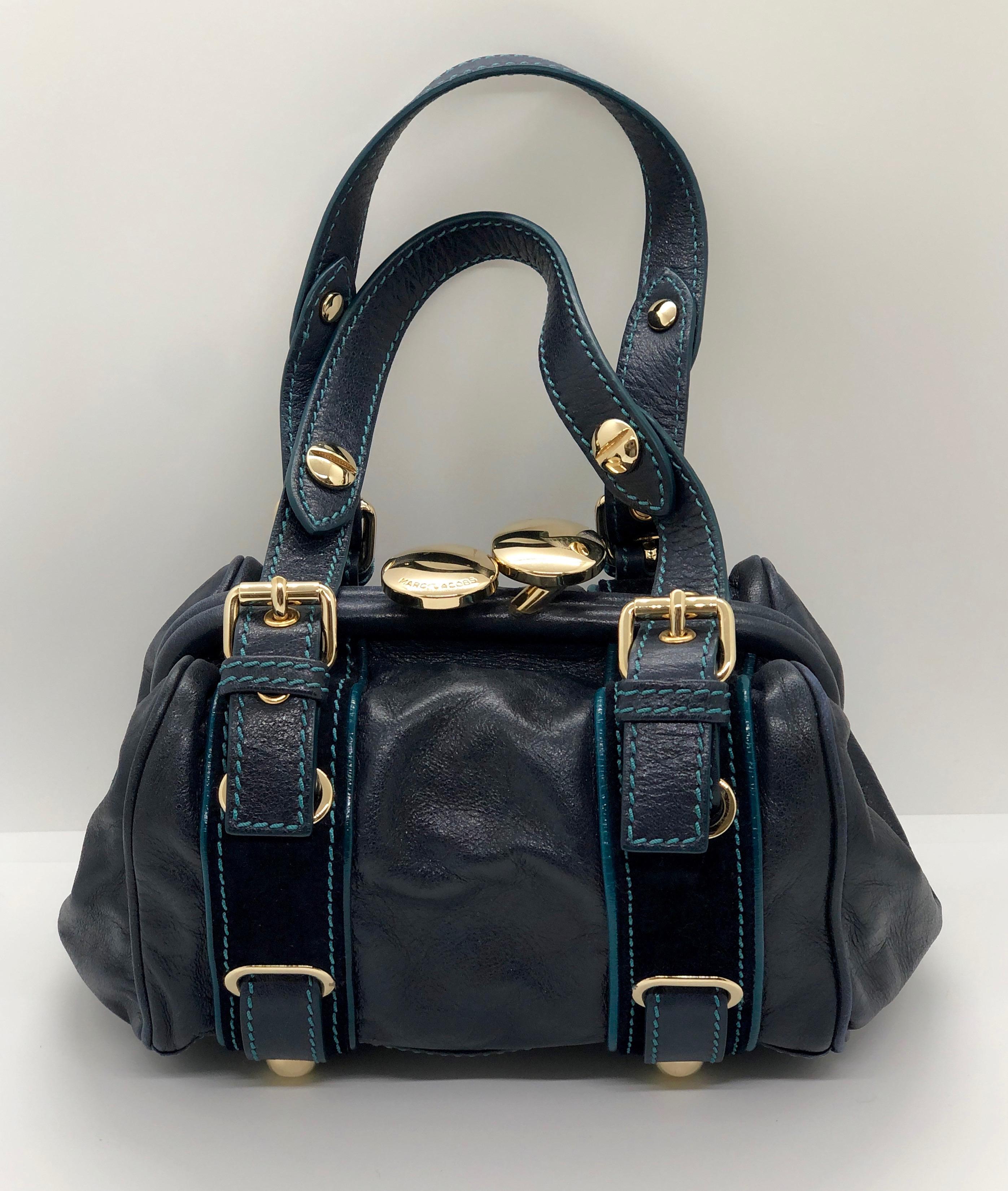 Make:  Marc Jacobs
Place of Manufacture:  Italy
Materials:  Leather, suede and metal
Color:  Navy Blue, teal blue and gold
Style:  Combination modified doctor's bag, shoulder bag, frame bag and modified duffle.  While being more petite, almost