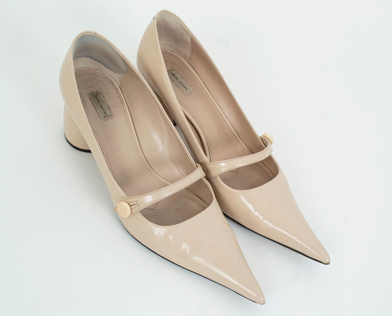 As only Marc Jacobs can, these Mary Janes include all the hallmarks of the classic shoe with a “left of center” slant. Featuring an extra-long pointed toe and rounded--almost-spherical--heel, these go-with-anything nude shoes are anything but boring