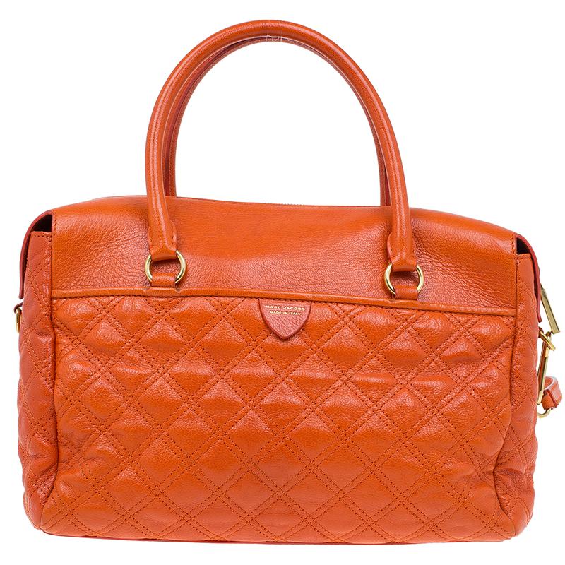 Marc Jacobs Rudi Satchel is high on style and sophistication. Crafted in orange leather, it is accented with quilted details and gold-tone hardware. This satchel features, dual top rolled handles and a detachable shoulder strap to flaunt it in