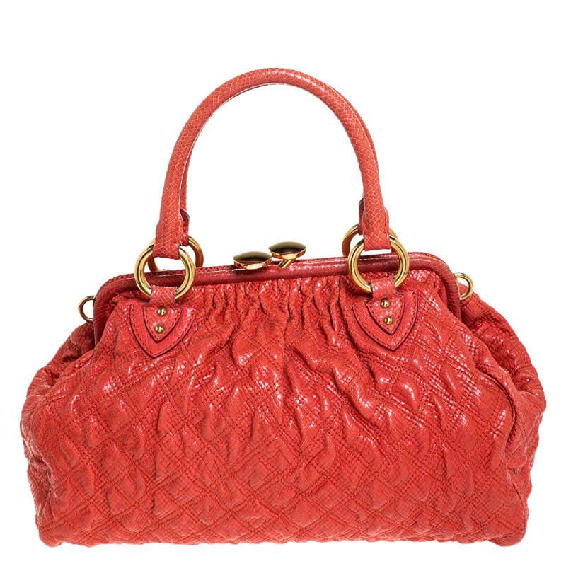 This Marc Jacobs design has an orange quilted exterior crafted from snakeskin-embossed leather and enhanced with gold-tone hardware. This elegant Stam bag features a kiss-lock top closure that opens to a fabric interior, dual top handles and a