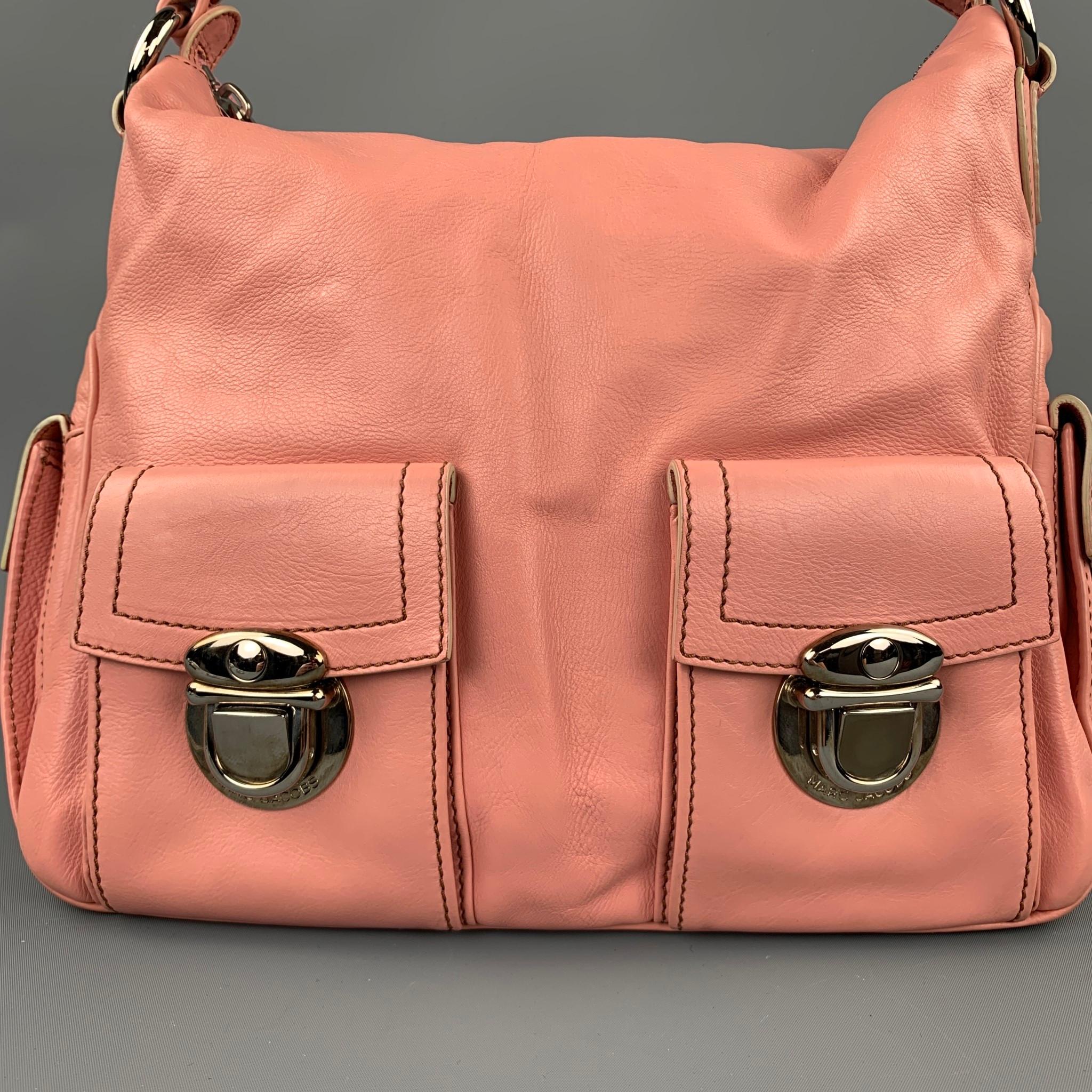 MARC JACOBS handbag comes in a pink leather with contrast stitching with a suede liner featuring top handles, silver tone hardware, pocket details, inner pocket, and a top zip up closure. Minor wear. Made in Italy.

Good Pre-Owned