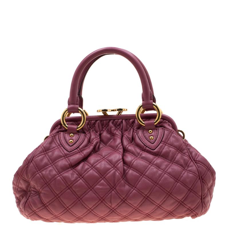 This Marc Jacobs design has a pink quilted exterior crafted from leather and is enhanced with gold tone hardware. This elegant Stam bag features a kiss-lock top closure that opens to a fabric interior, dual top handles and a removable shoulder strap