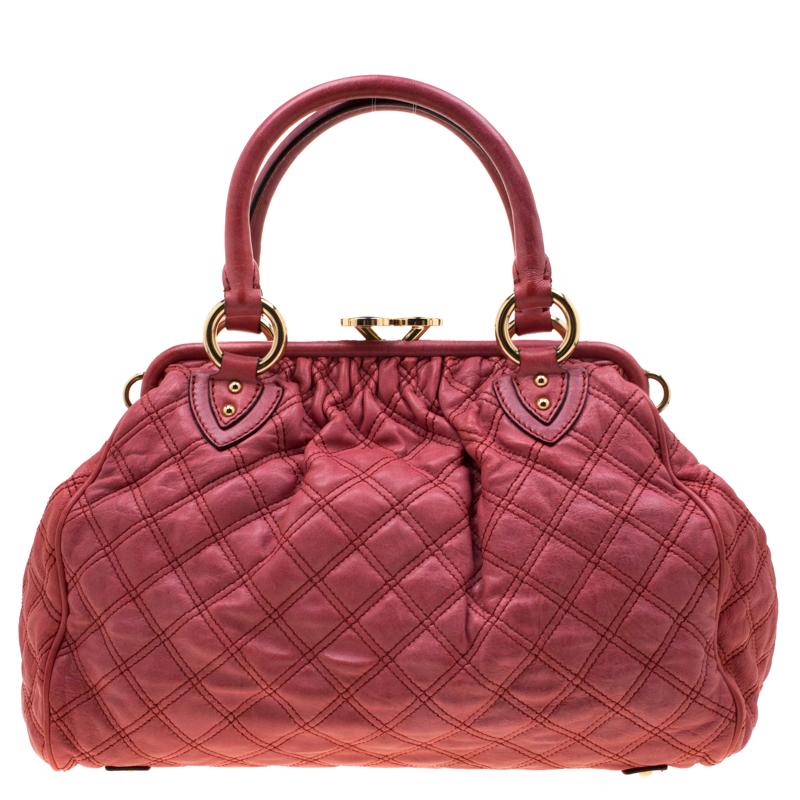This Marc Jacobs design has a pink quilted exterior crafted from leather and enhanced with gold-tone hardware. This elegant Stam bag features a kiss-lock top closure that opens to a fabric interior, dual top handles and a removable chain that
