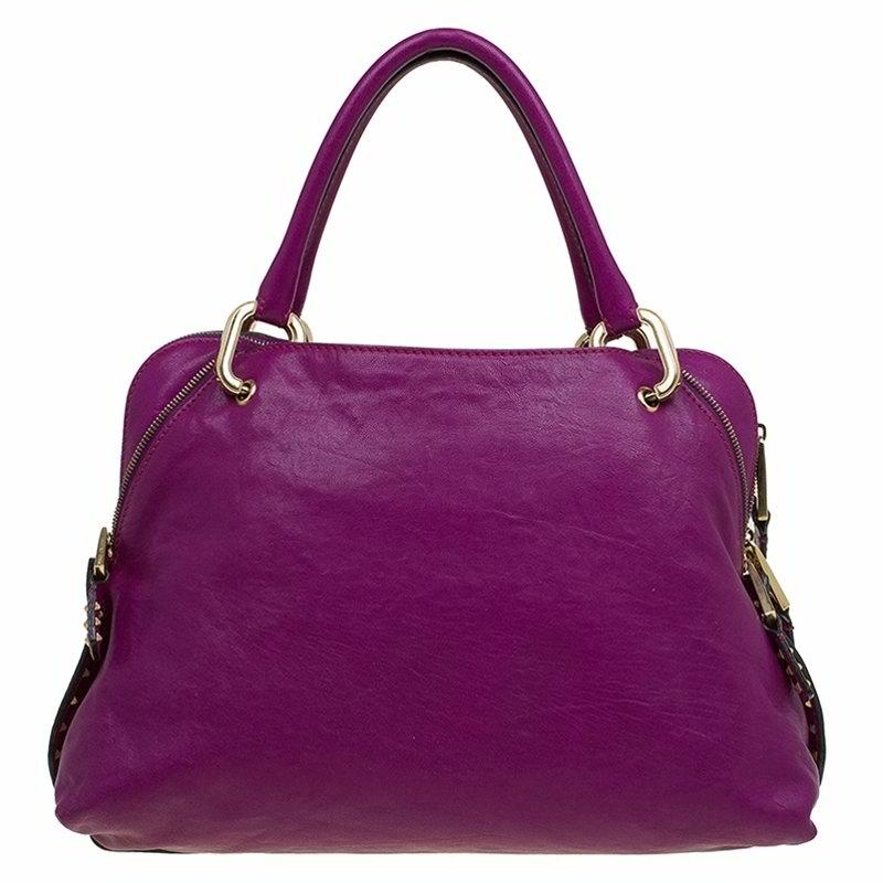 This 'Paradise Little Janice' bag from Marc Jacobs is crafted from purple leather and accented with gold-tone hardware for luxe appeal. It features a signature designer embossed padlock to the front and pouch pockets to the front and back. The sides