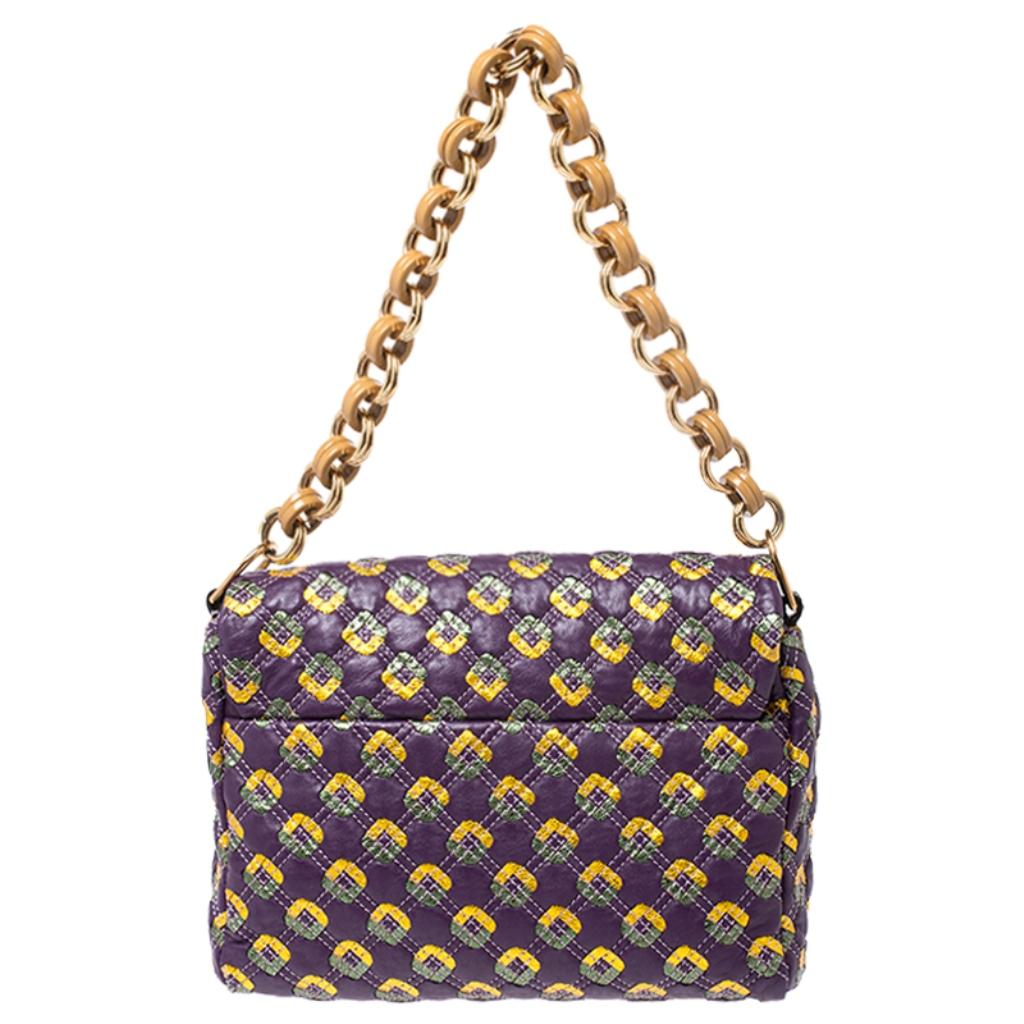 A stunning leather bag to look fashionable this season. Get yourself this satin-lined bag now. This bag from Marc Jacobs features prints and quilting all over its exterior. Carry this purple bag to your next event for a statement-making