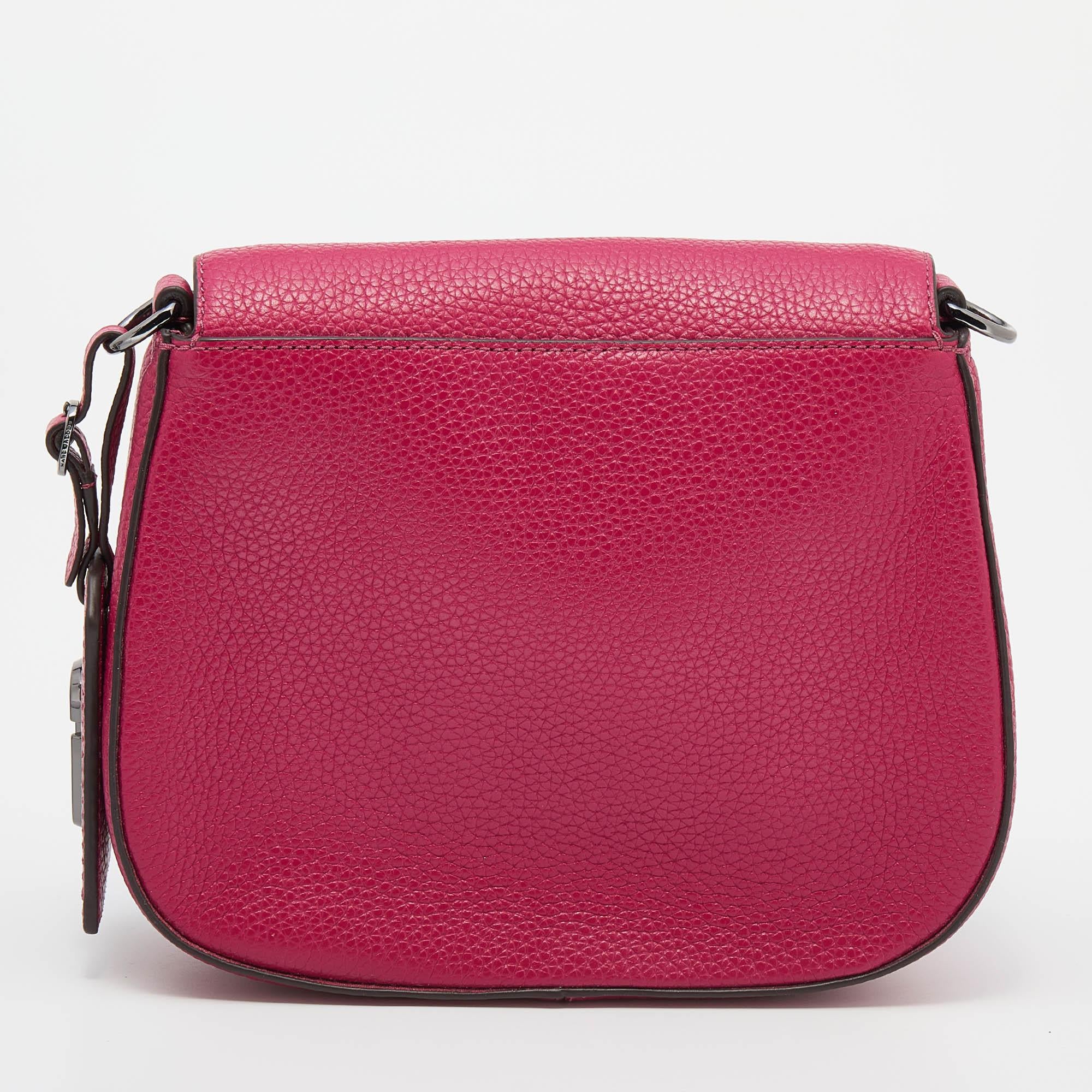 Minimal in style, this Marc Jacobs bag is worthy of a place in your wardrobe. While the exterior is made from raspberry leather, the interior is lined with fabric. The front zipper pocket, shoulder strap, and brand detailing on the front complete