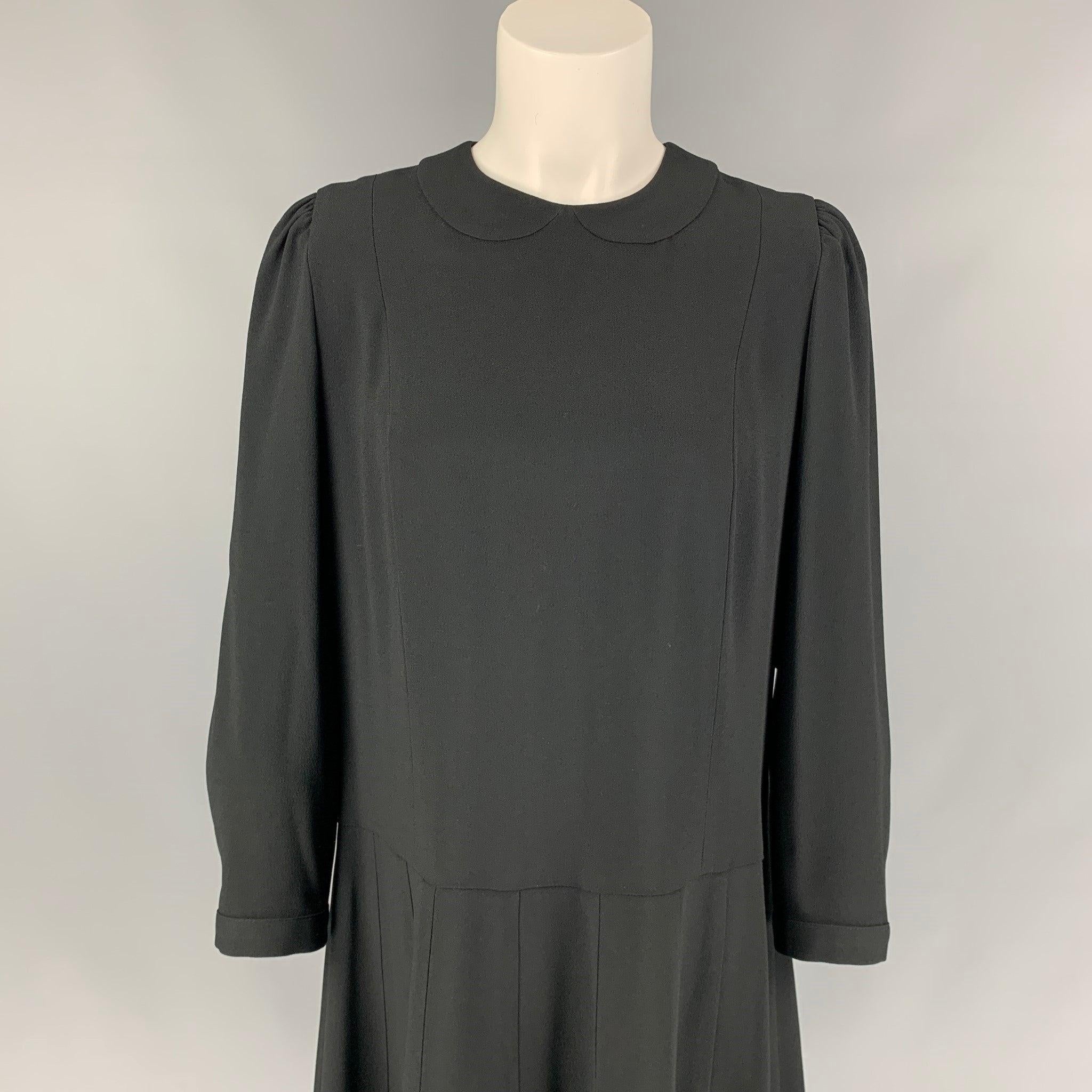 MARC JACOBS RUNWAY dress comes in a black acetate / viscose featuring an a-line style, long buttoned sleeves, pleated skirt, back bow details, and a hook & loop closure. Made in USA. Very Good
Pre-Owned Condition. 

Marked:   6 

Measurements: 
